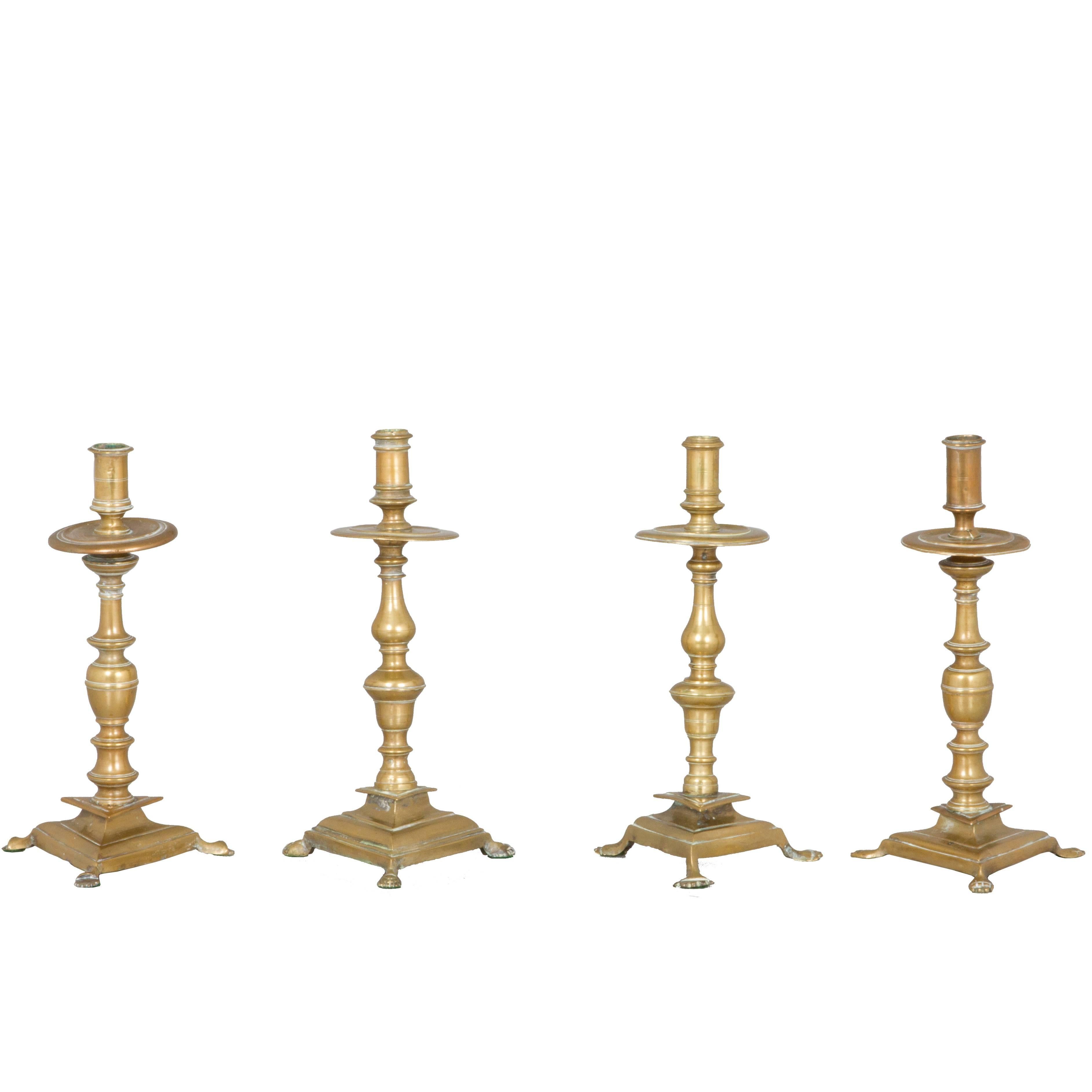 Two Near Pairs of Brass Footed Candleholders