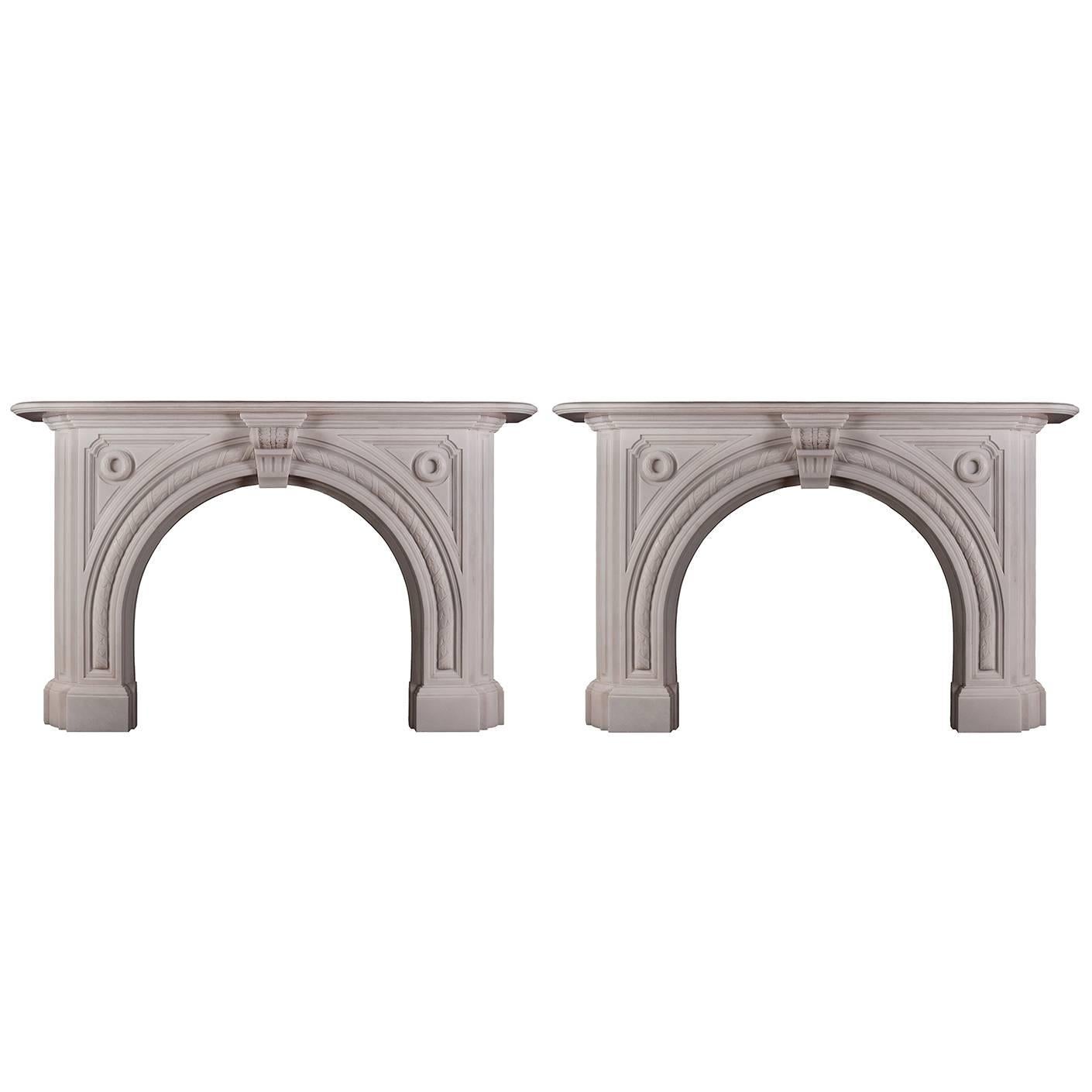 A pair of Victorian fireplace mantels in white marble