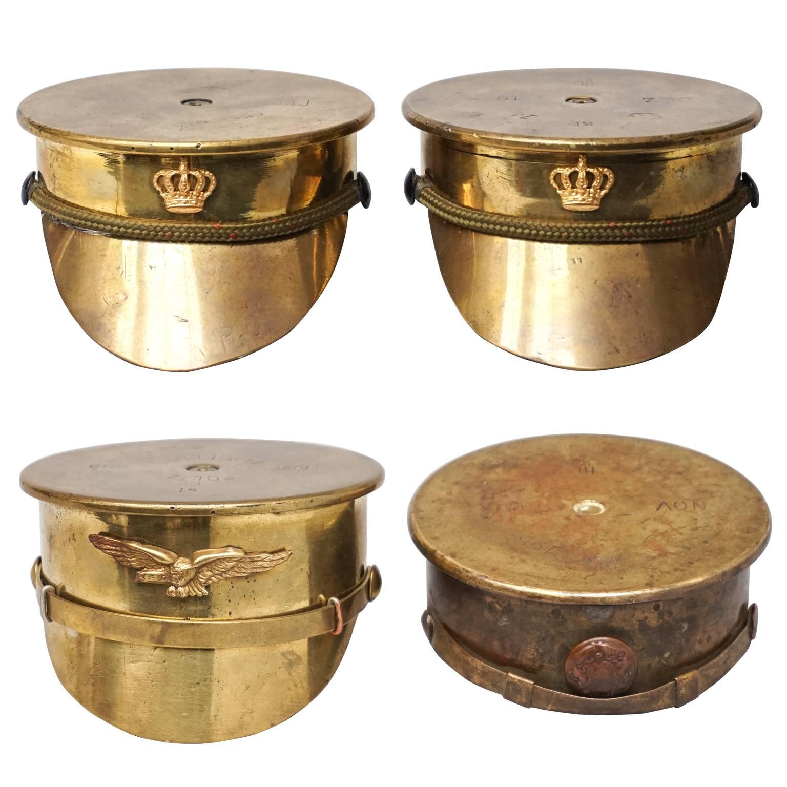 Collection of Four Brass 'Trench Art' Military Caps or Kepis WWI