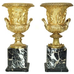 Pair of Neoclassical Gilt Bronze Figural Medici Style Urns on Marble Base 
