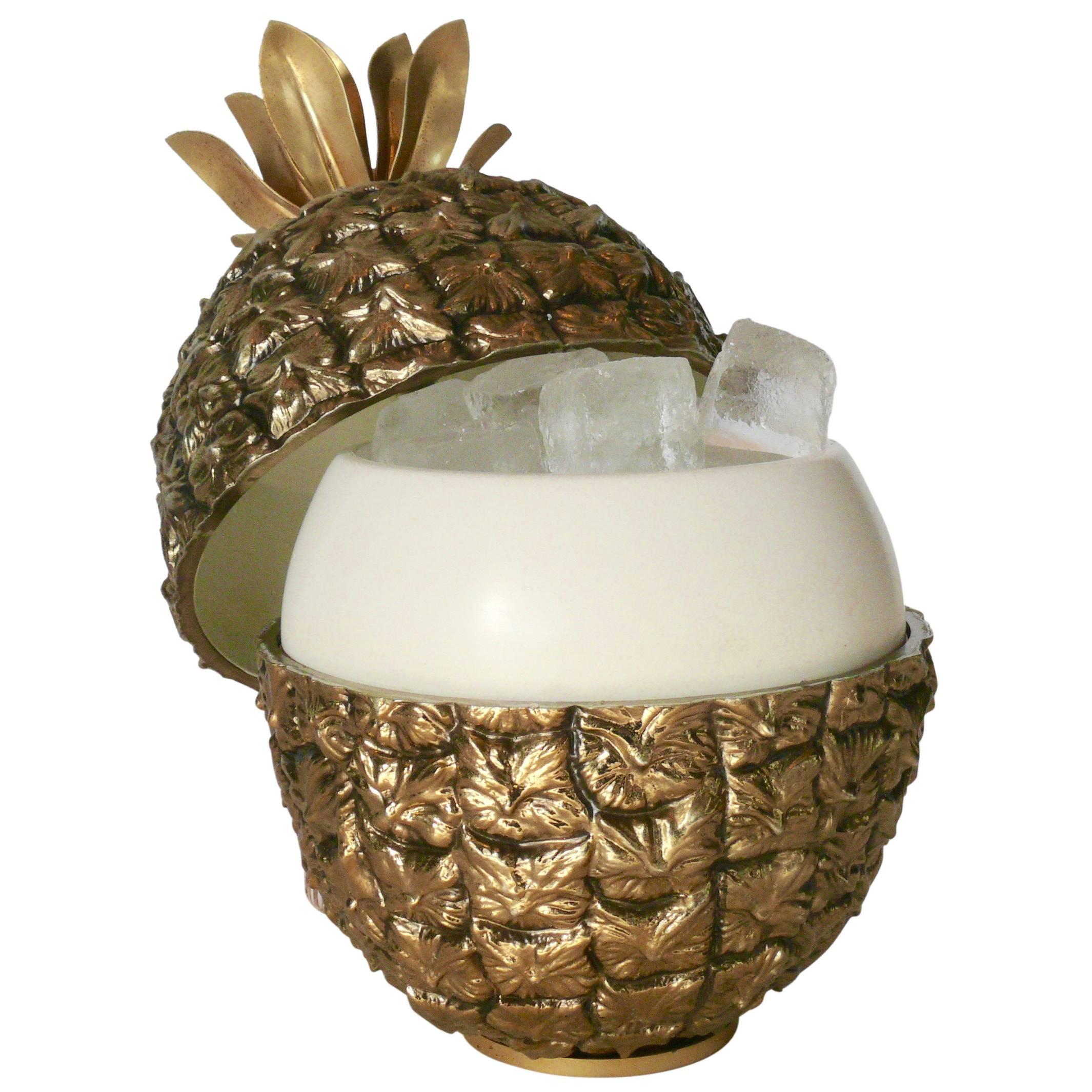 Wonderful brass plated pineapple shaped ice bucket by Michel Datois, Paris, 1970s. Constructed of of brass plated plastic, solid metal base stamped with 'Made in Paris', and adorned with beautiful metal leaves on top that serve as a handle.