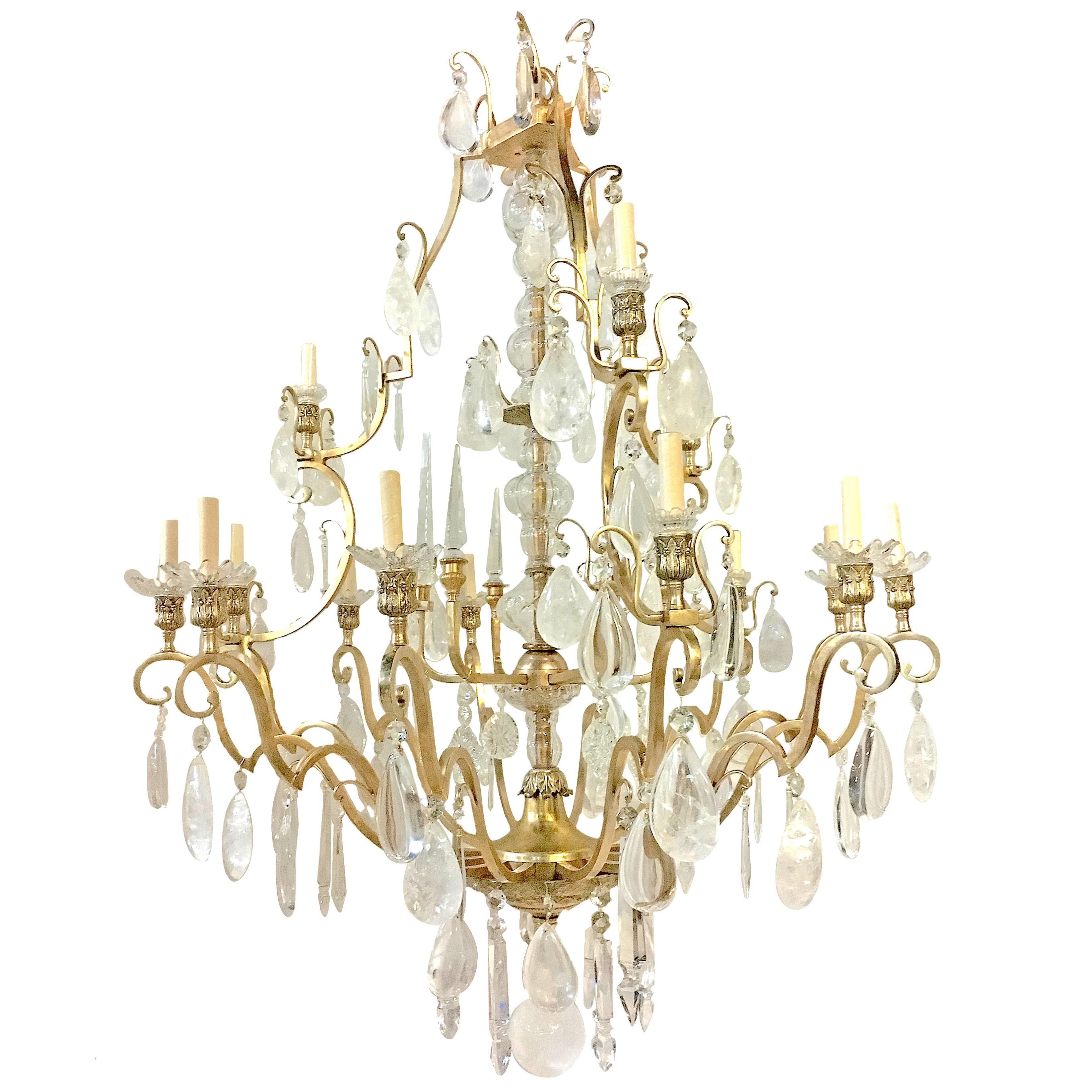 A large 1920s neoclassic style rock crystal chandeliers with 18 lights each. The body made of patinated bronze and with rock crystal and crystal pendants. Garnished with crystal spears.

Measurements:
Height: 58