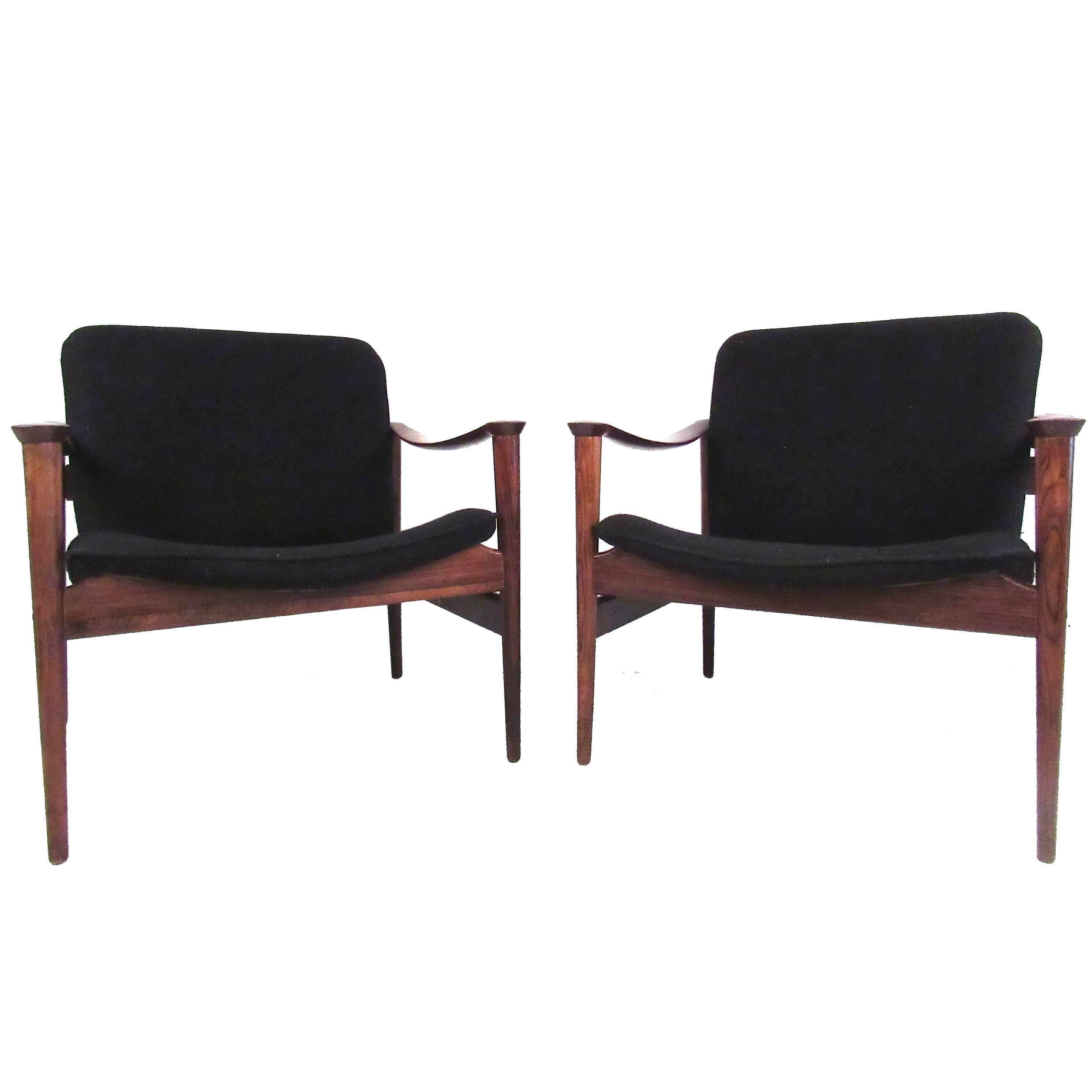 Elegant pair of sculptural rosewood lounge chairs by the Danish designer Fredrik A. Kayser. This impressive mid-century pair of armchairs make comfortable office seating area chairs, stylish side or accent chairs, and make a memorable Scandinavian