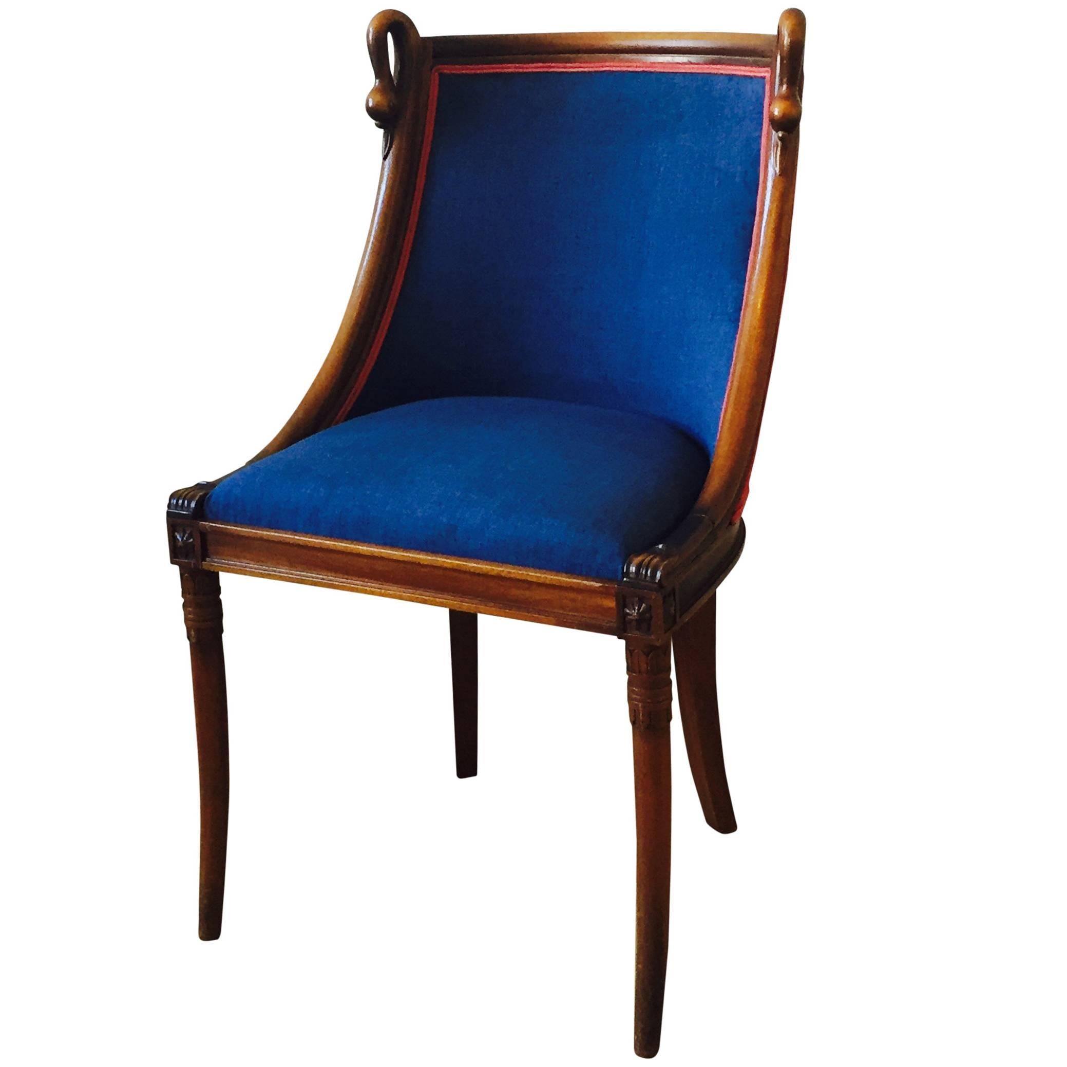 Momiq chair 'Lovebirds' is a small fruitwood chair with curved swan necks. The chair is from the 20th century and Empire style. Chair lovebirds has been adjusted to Momiq design and has been upholstered with a blue fabric from Houles at the front.