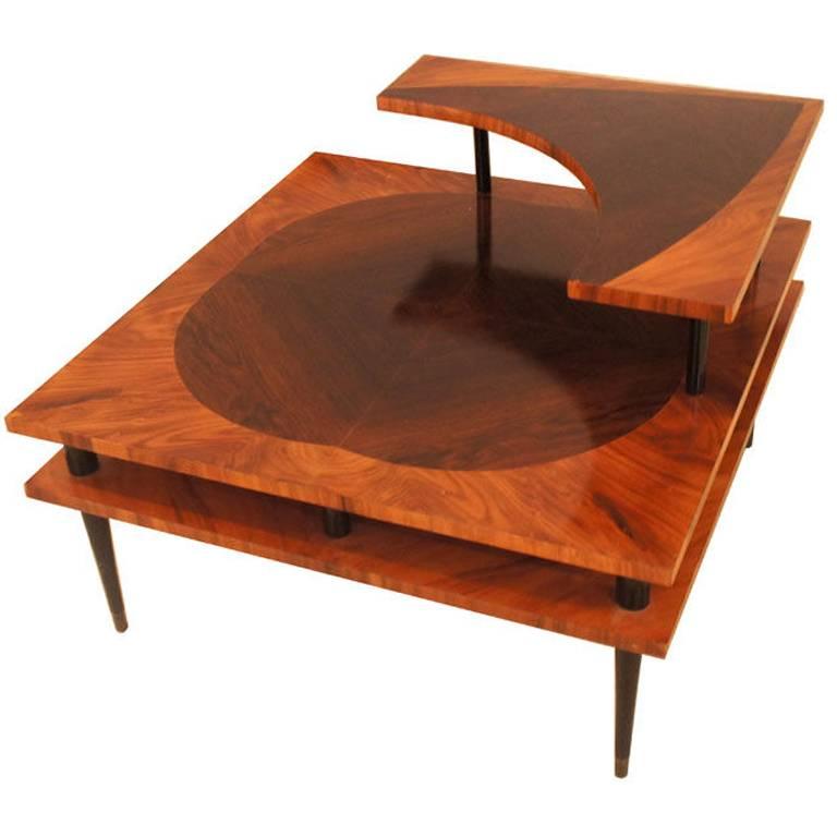 Three-tiered side table with marquetry details and black lacquered feet.
Unattributed.