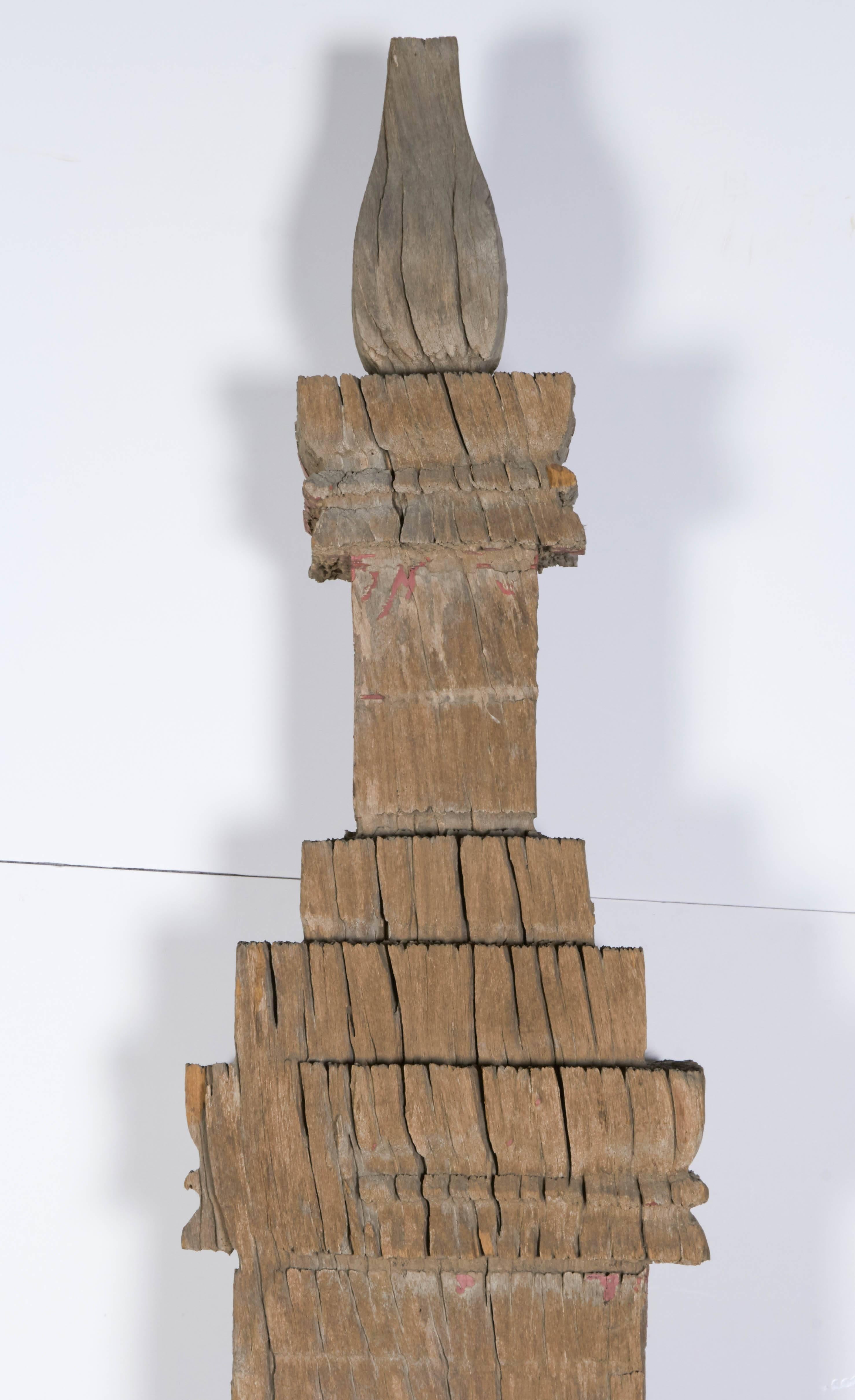 A beautifully weathered and very tall antique temple pillar from Laos. This pillar has a very graceful form with an offering box in the centre of the piece. The extraordinary surface was created by years of exposure to the elements in the hot and