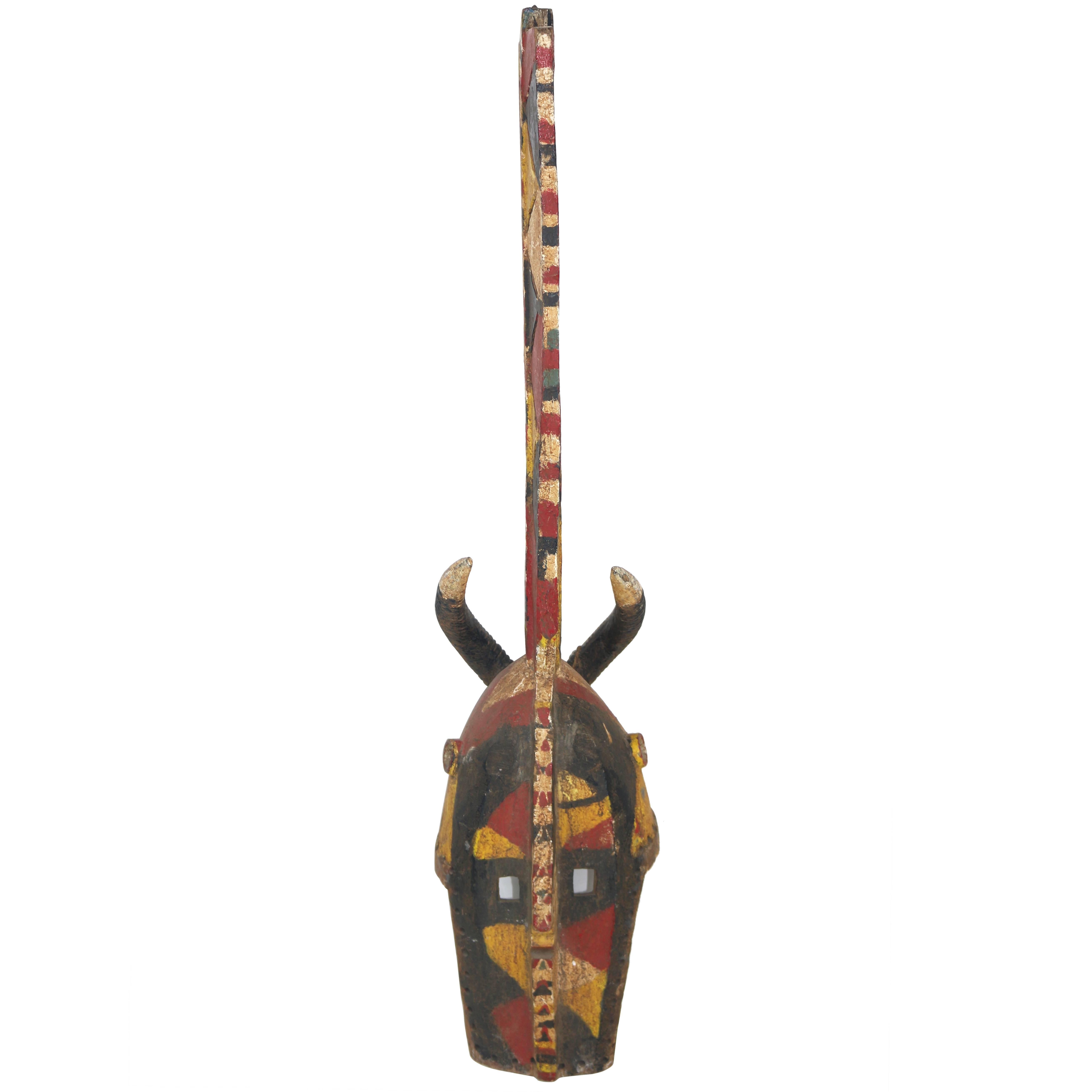 Powerful Tall Wood African Carved Pigmented Mask  For Sale