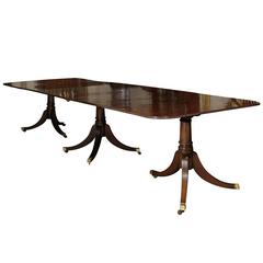Three-Pedestal Mahogany Dining Table with Two Leaves and Brass Castors