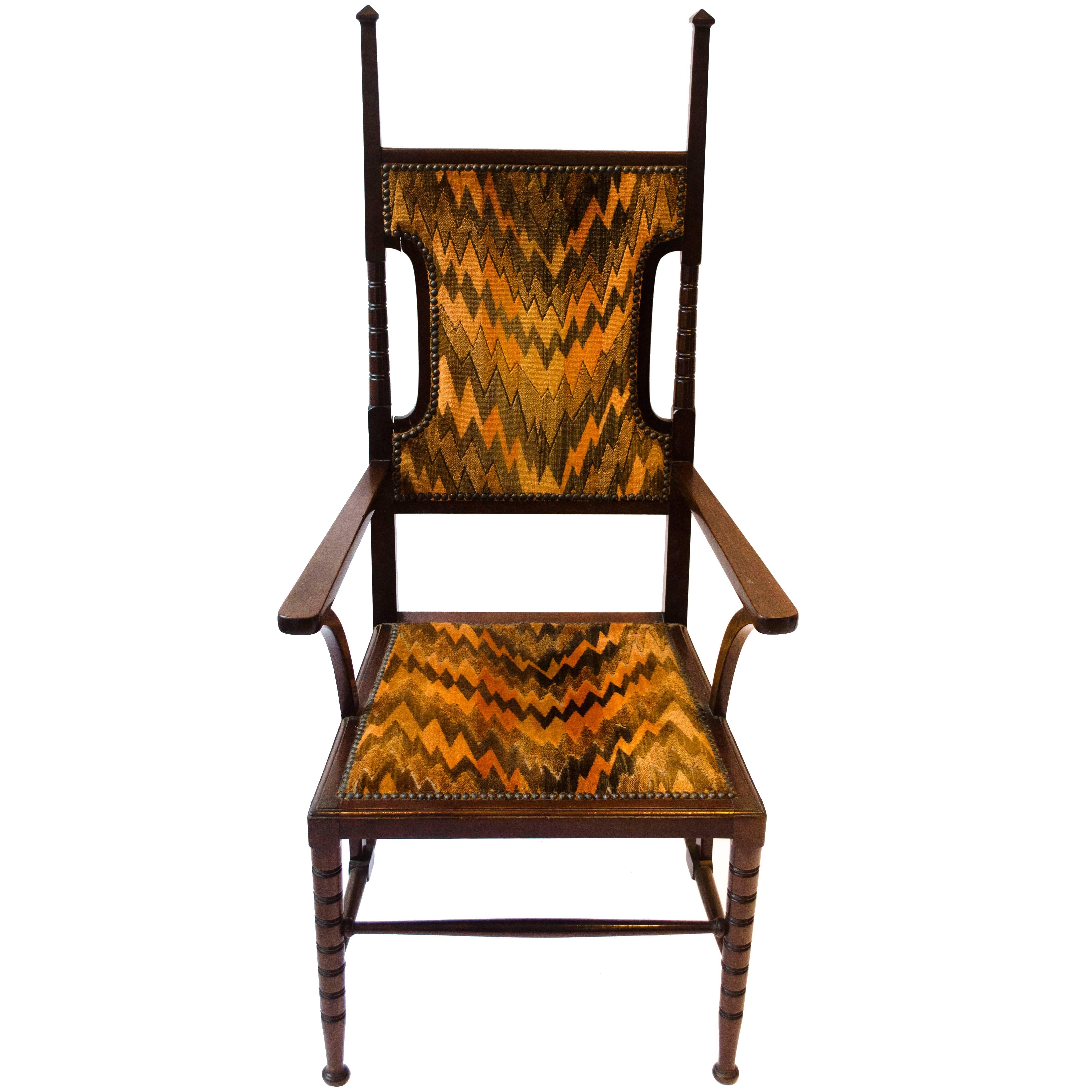 Liberty and Co Attributed. A late Aesthetic Movement Walnut Armchair. For Sale