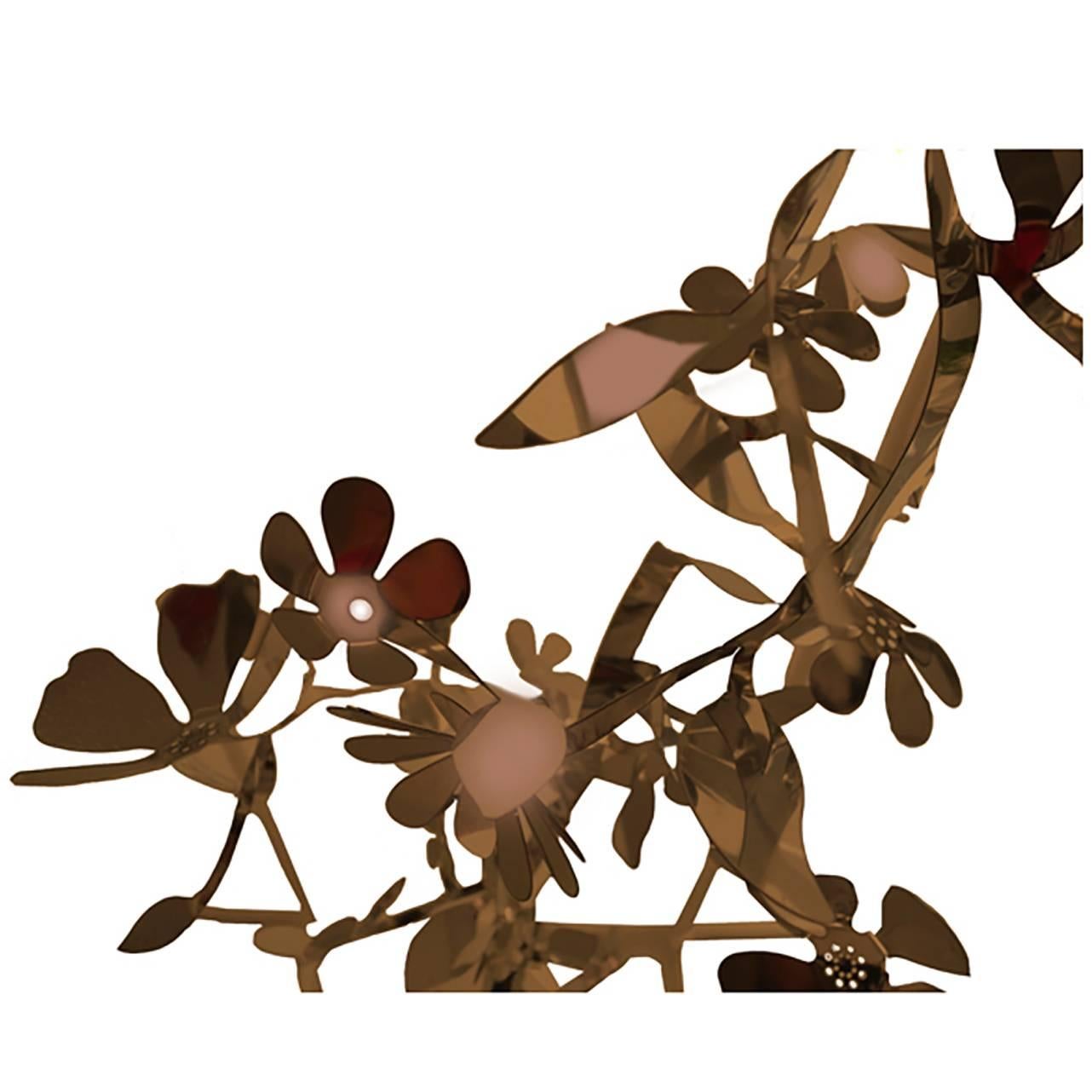 Larger than life, flora's vine like metal garland is an arresting architectural element. Crafted from 1/8” sheet metal, flora can be twisted and turned to form your favorite arrangement, and is easily suspended by a wire cable. Suitable for indoor