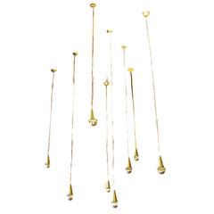 Set of Eight Small Brass Pendants