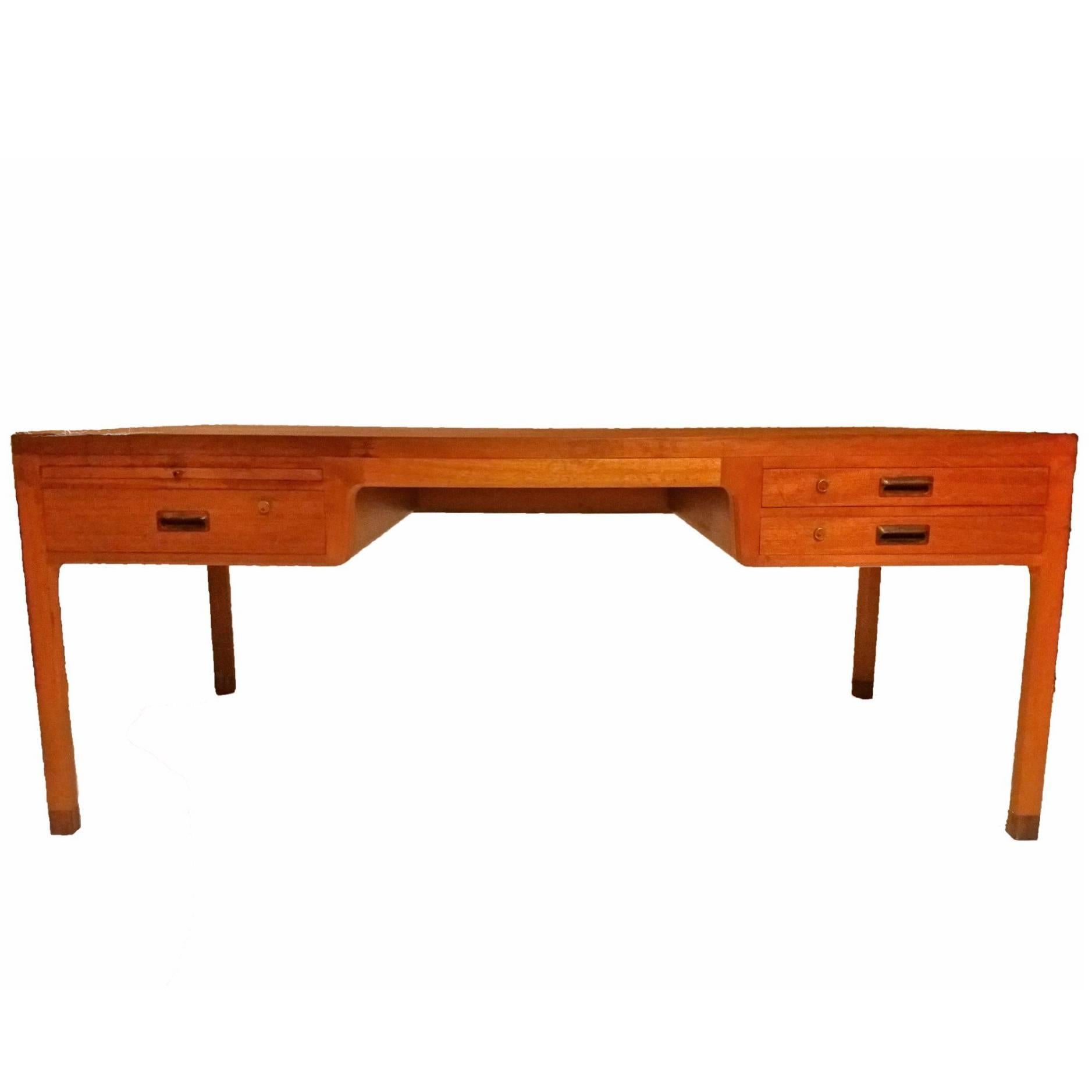 Superb Danish Mid-Century Modern freestanding desk by Aksel Bender Madsen & Ejner Larsen for Willy Beck. This handcrafted teak desk comes with two drawers on one side and one drawer and a pull-out writing surface on the other. The drawers have
