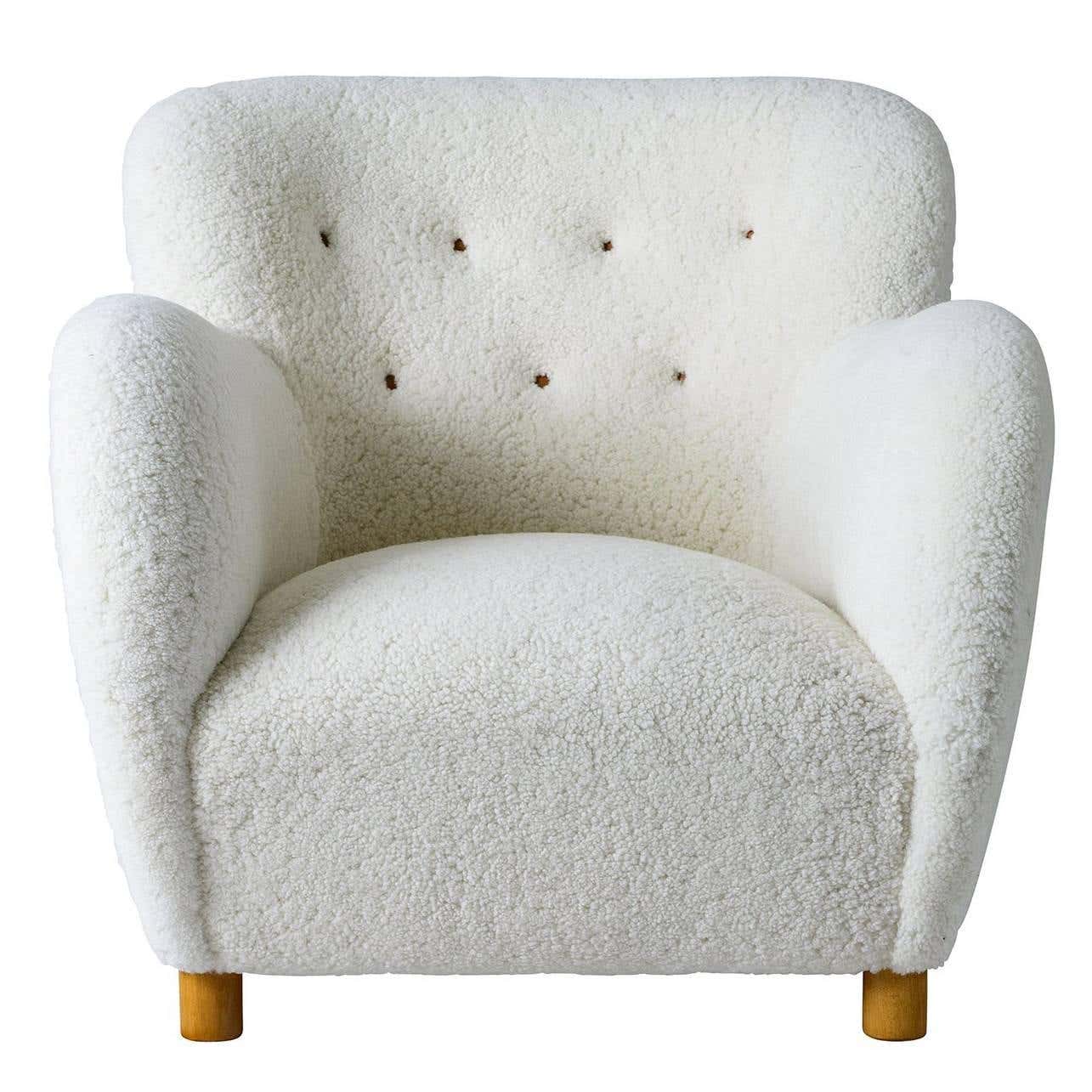 Scandinavian-inspired accent chair with sheepskin throw