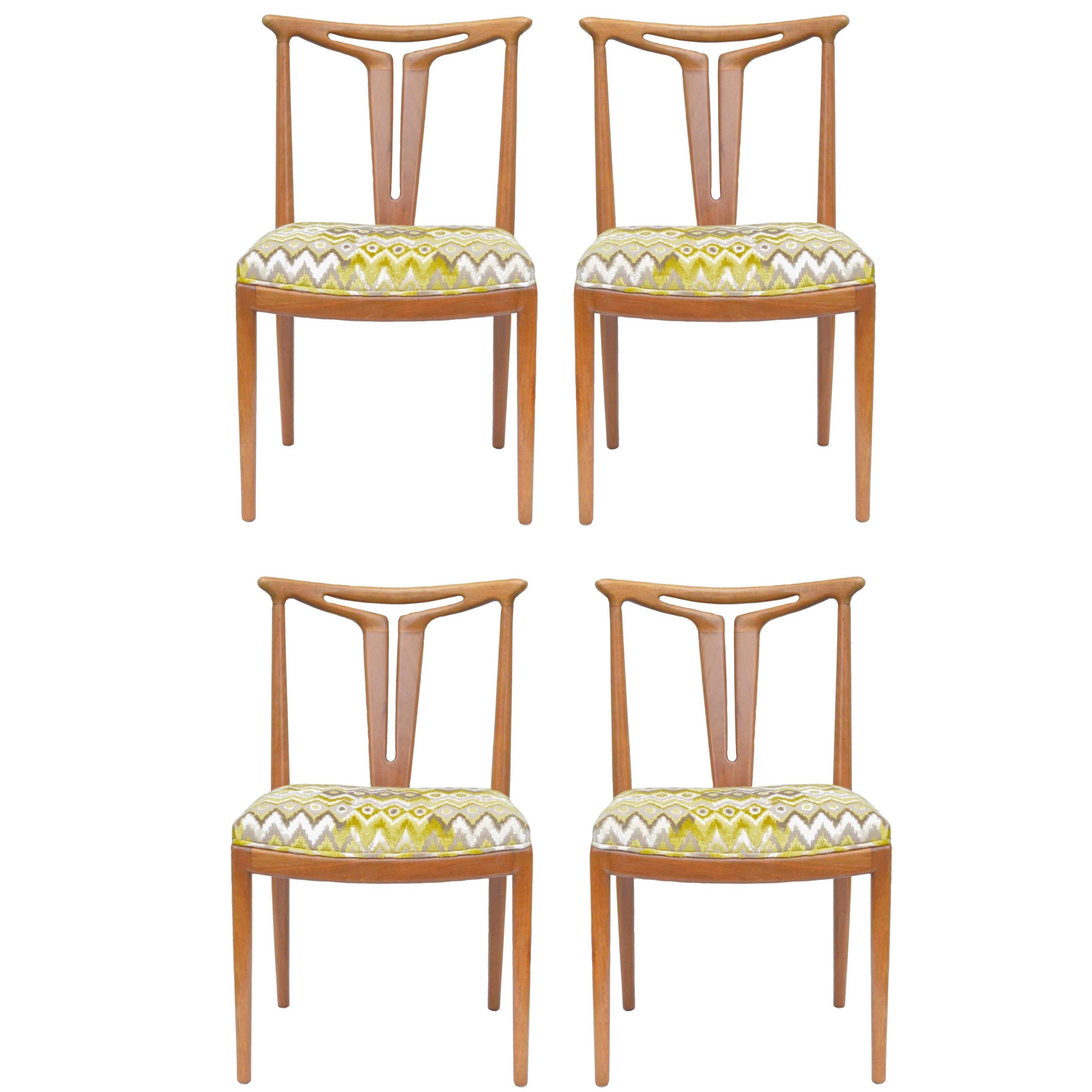 Gorgeous set of four modern dining chairs of walnut having very unique "T" back splats. The chairs have just been dressed up in a chic ikat fabric by Kravet Couture. All chairs very sturdy and tight having recently been gone over, they are