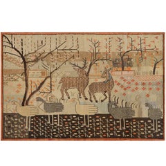 Tapis Khotan du Turkestan oriental du début du XXe siècle avec des cerfs et des oies