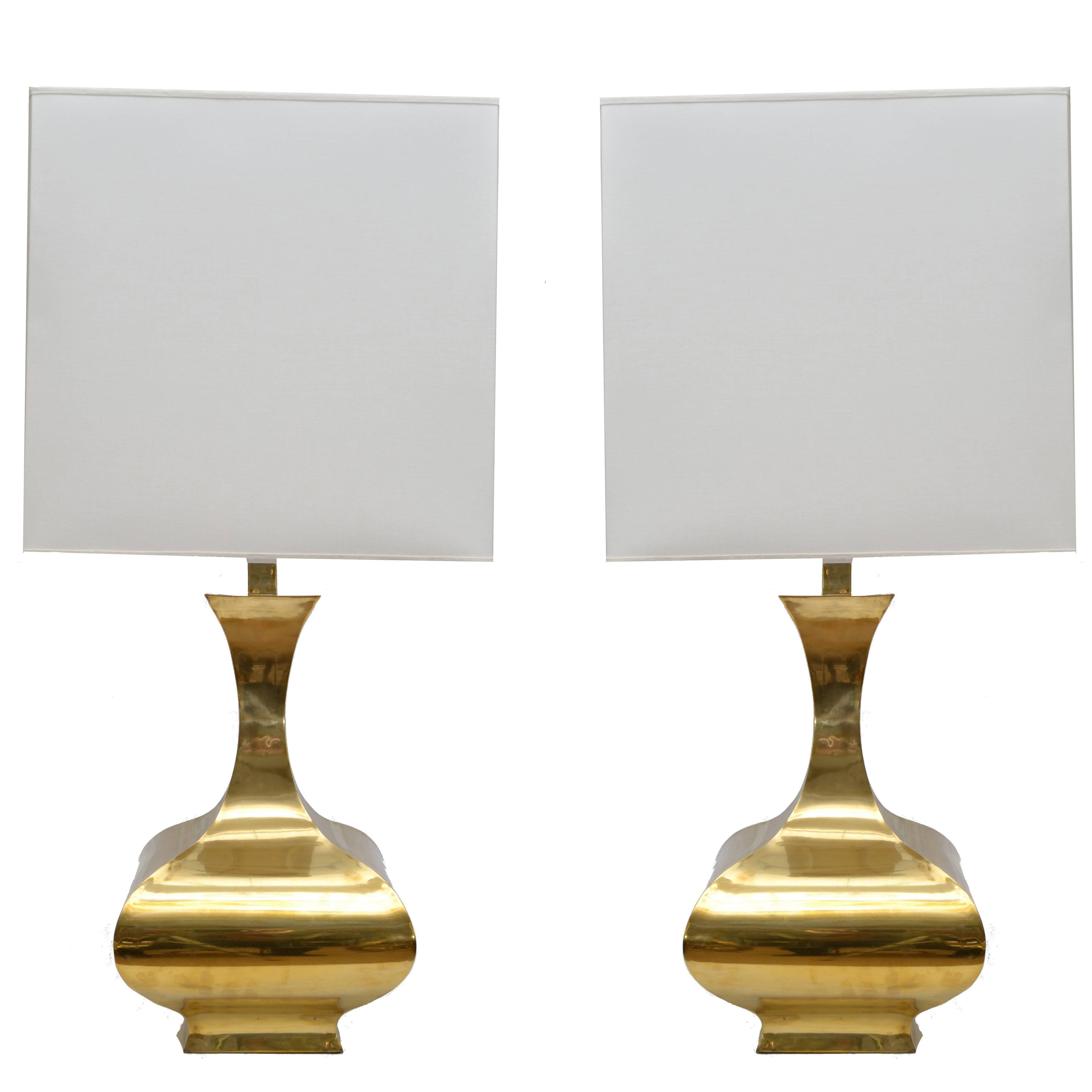 Stunning Mid-Century Modern pair of solid brass table lamps in vessel shape with shades.
In perfect working condition and each lamp uses 2 max. 60 W light bulbs.
Height to top of lamp: 39.5 inches.