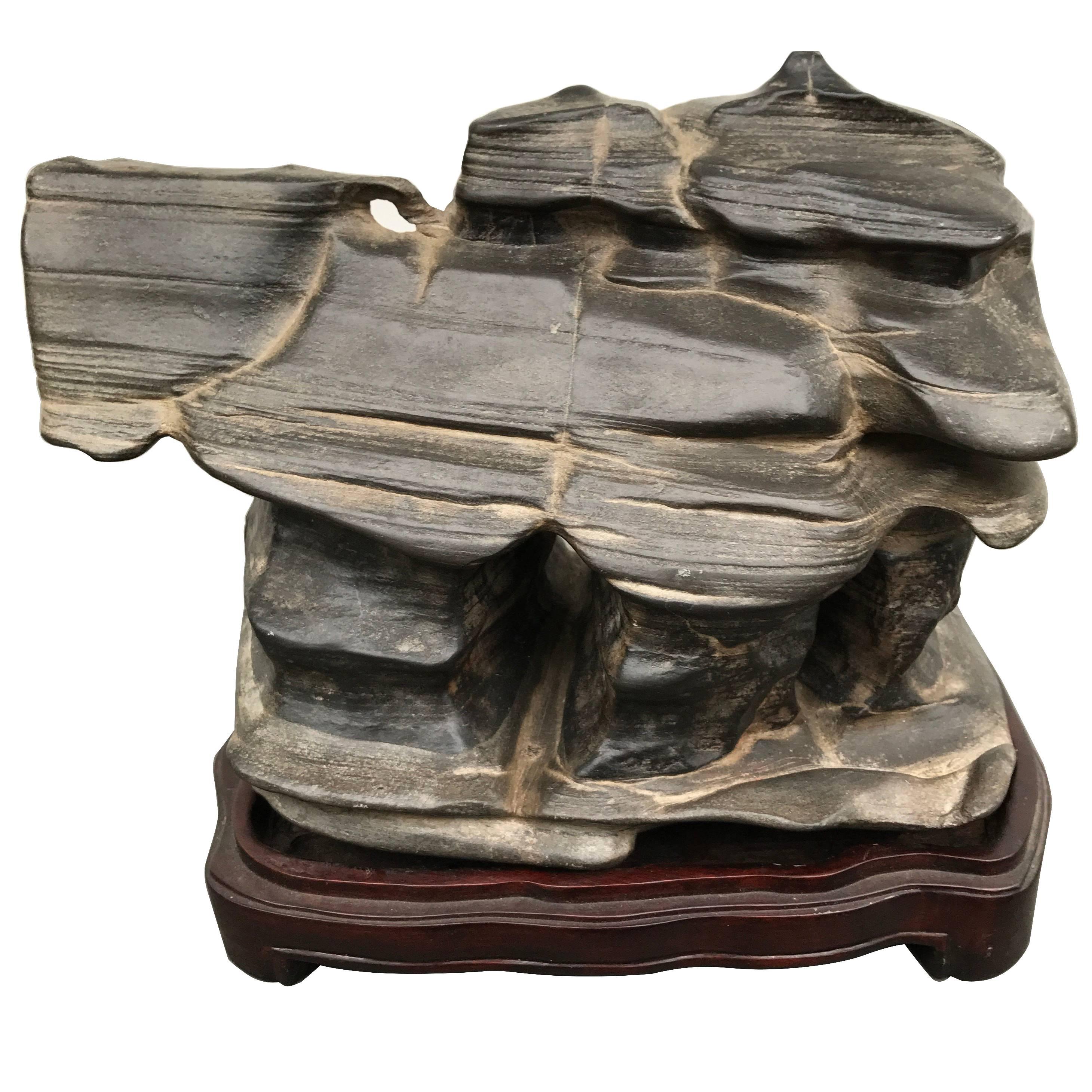 This is a beautiful example of a unique, natural organic Chinese, Wuling- Viewing stone or scholar rock in the form of a surreal architectural structure.

Notice its smooth natural wavy appearance caused from natural earth forces taking millions of