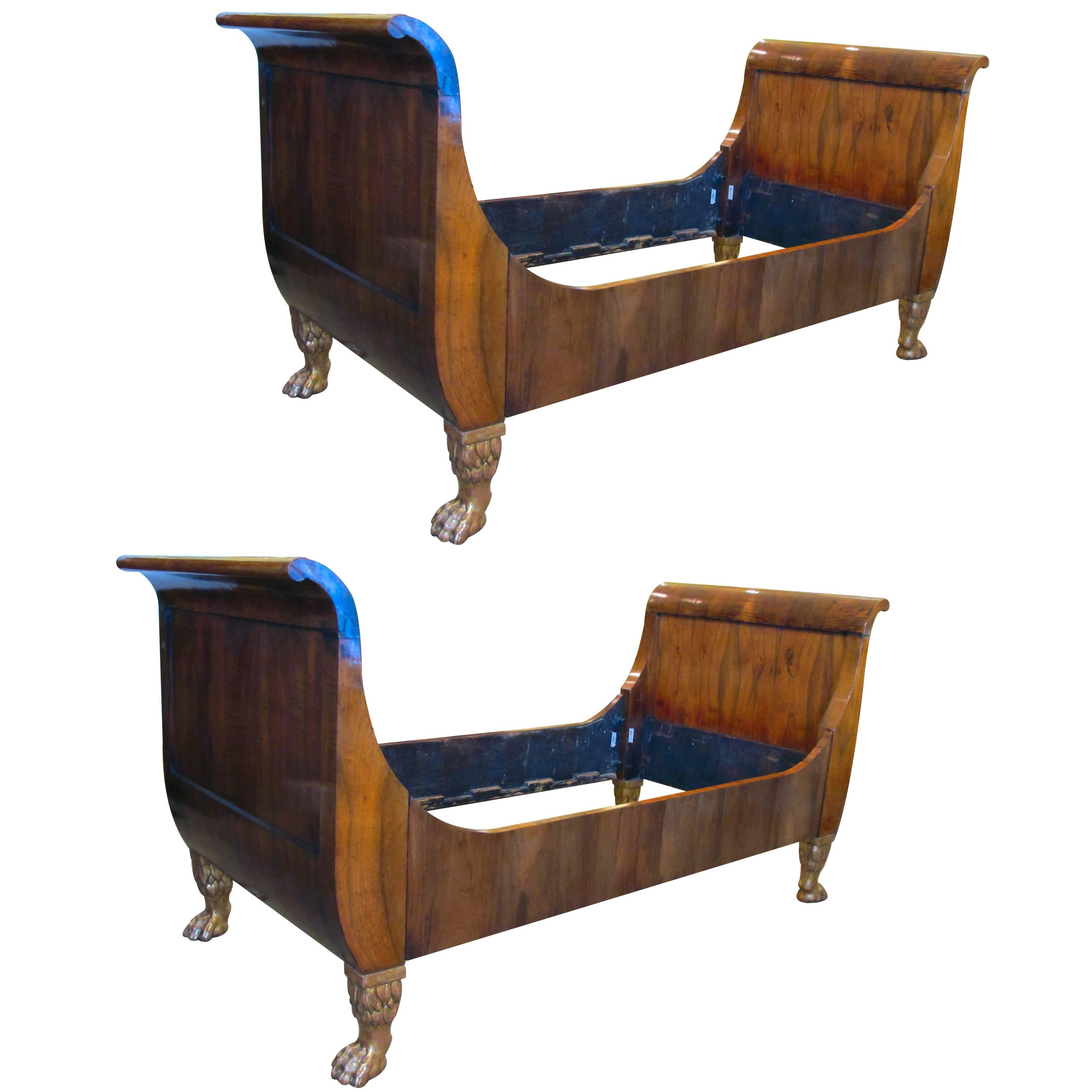 Handsome Pair of French Empire Walnut Sleigh Beds with Giltwood Hairy Paw Feet