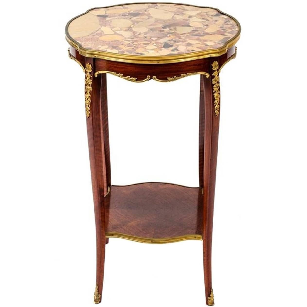 Louis XV style gilt and marble-top gueridon or side table, Early 20th century.  Bronze accents and stretcher shelf.
   