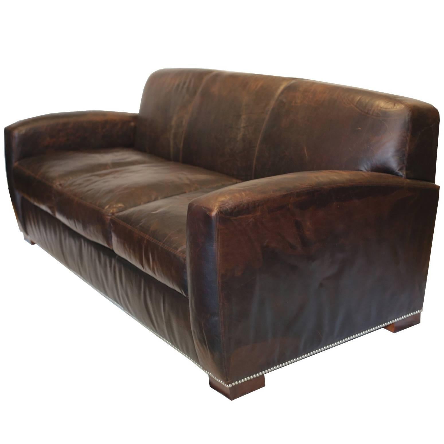 New sofas. Never been used. 
1940s inspired leather sofa by Ralph Lauren Home. This leather will wear well over the years and improve with age and use. Rich, dark brown leather with two large 22" x 22" leather pillows, burnished Mahogany