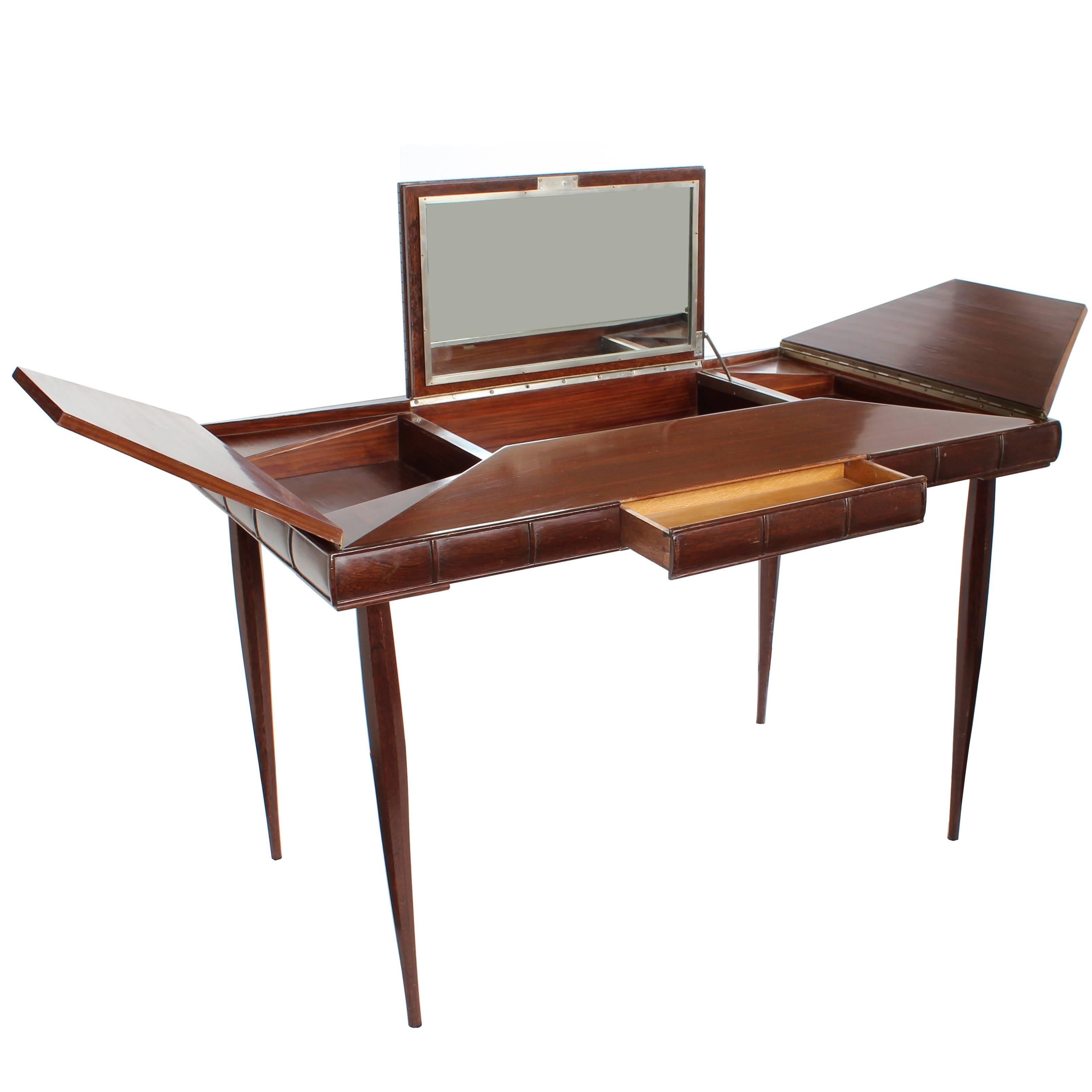 A French art Deco palissandre (rosewood) and palm wood envelope-style vanity with center fold up mirror, drawer and two-fold up side compartments, circa 1940.

Architect, Sandy Littman of Duesenberg LTD.  and The American Glass Light Company have