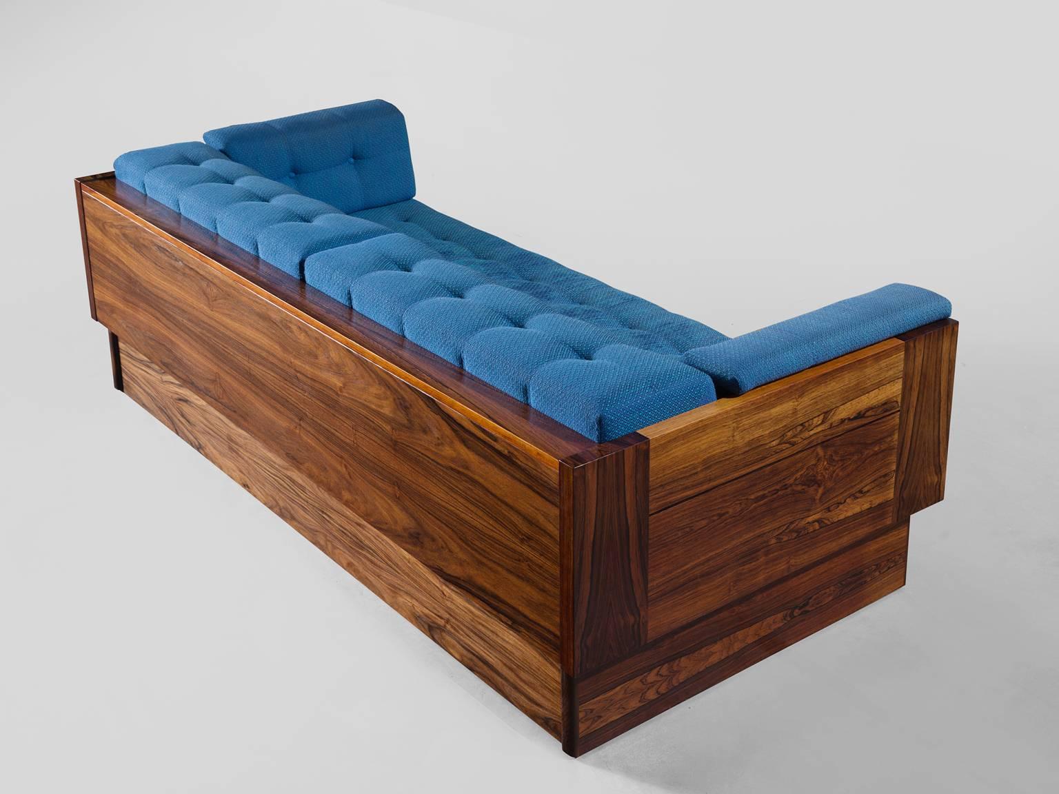 Daybed, rosewood, fabric, foam, Norway, 1960s.

Stately and comfortable sofa. This three-seat sofa is robust and simplistic at the same time. The warm grains of the rosewood are complimentary to the geometric and strong rosewood frame. It functions