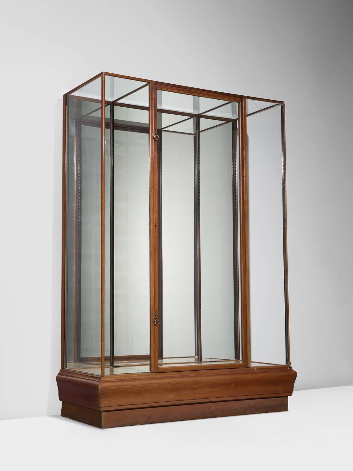 Vitrine, wood, glass, steel, Europe, 1960s.

Sturdy and minimalist showcase in glass and wood. The base of this vitrine is beautifully simply designed as it features a wooden foot that is built up of two layers of which the top one is slightly