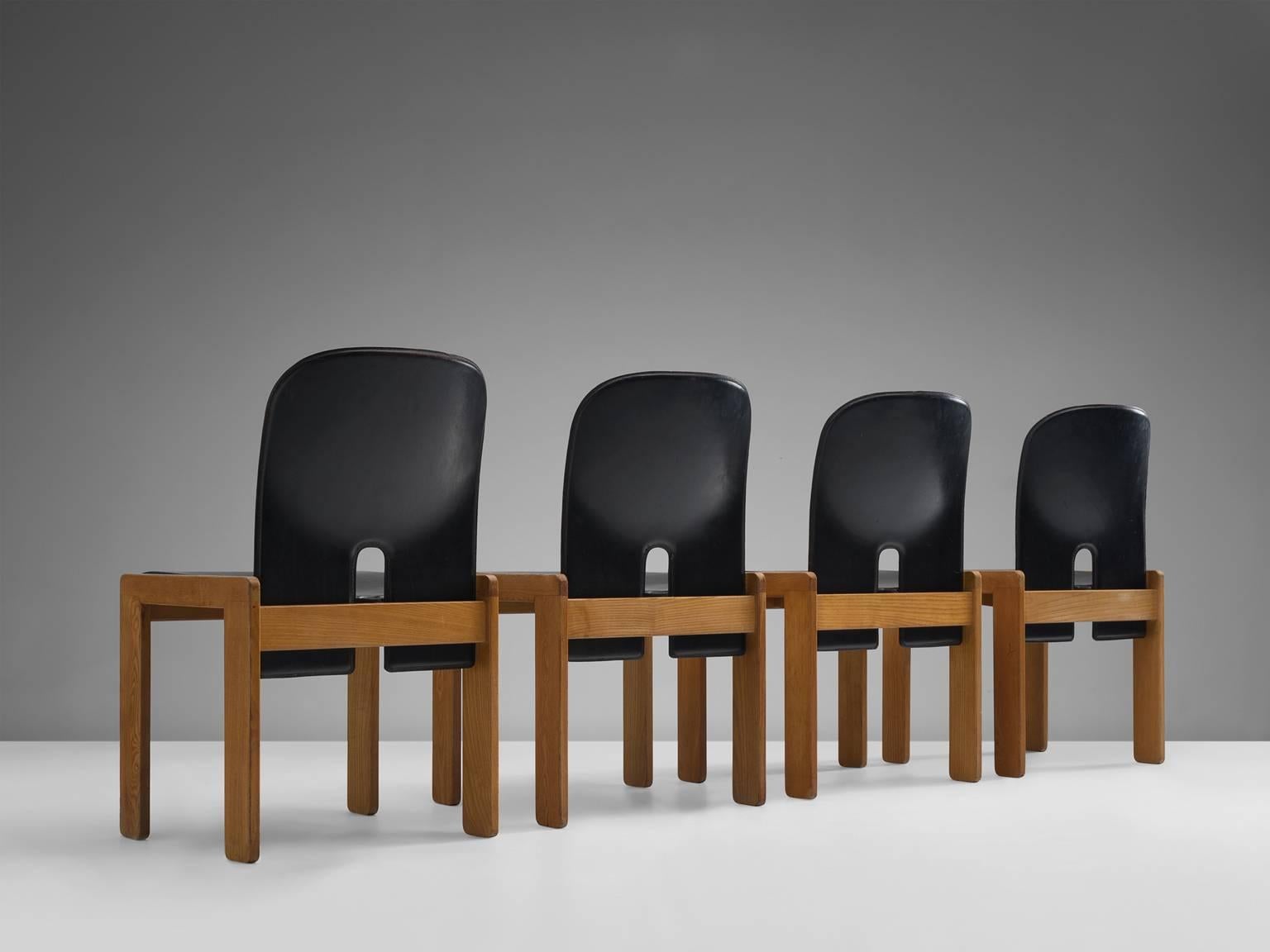 Set of four chairs model 121, in wood and black leather, by Afra & Tobia Scarpa for Cassina, Italy, 1965.
 
Set of four chairs by Italian designer couple Tobia and Afra Scarpa. These chairs have a cubic and basic appearance. The base consist of four