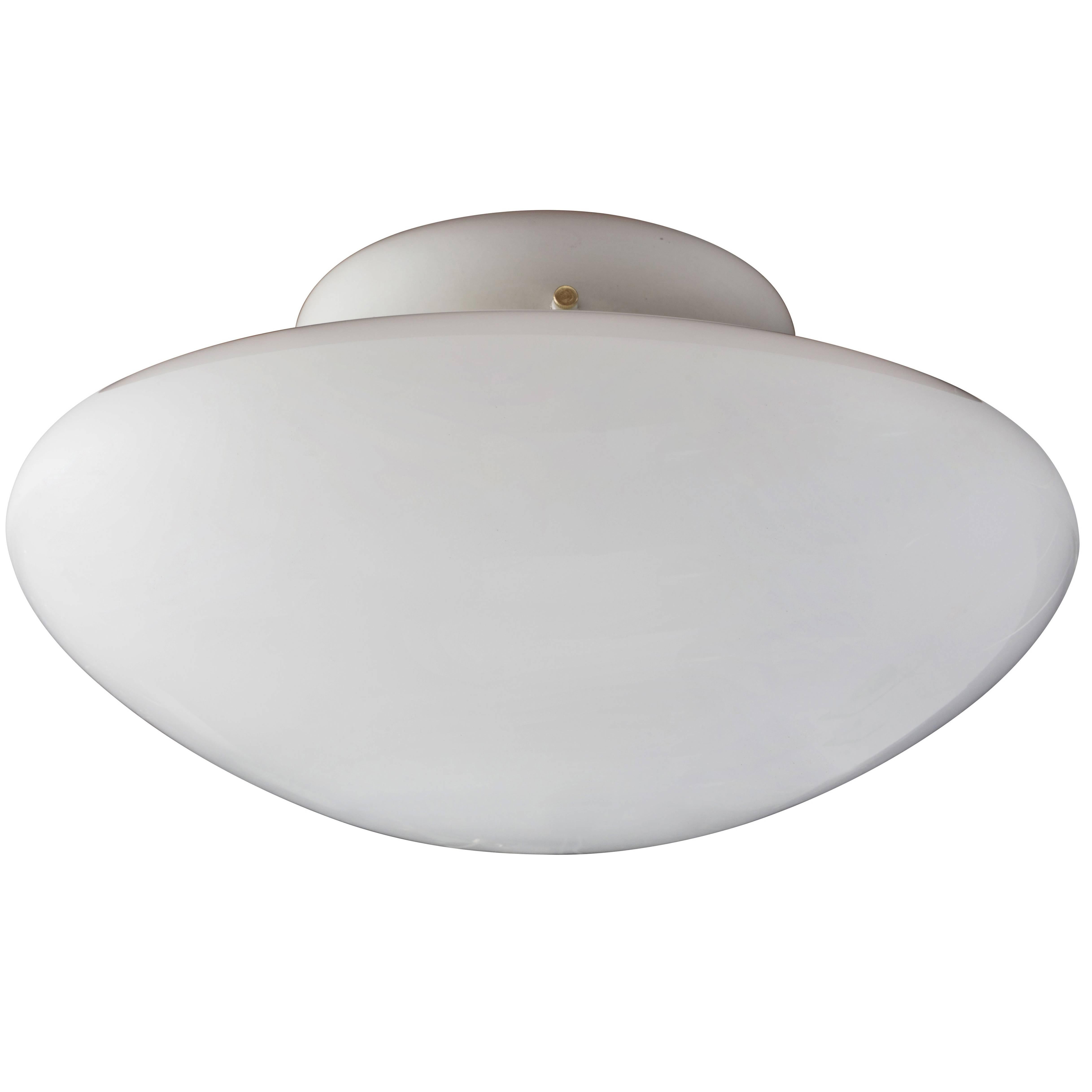 Large Sergio Mazza 'Magnolia' ceiling lamp for Quattrifolio, circa 1971. Executed in a seemingly floating bilious hand blown opaline glass shade below a Minimalist white enameled metal base for Quattrifolio, Italy. An extremely clean and sculptural
