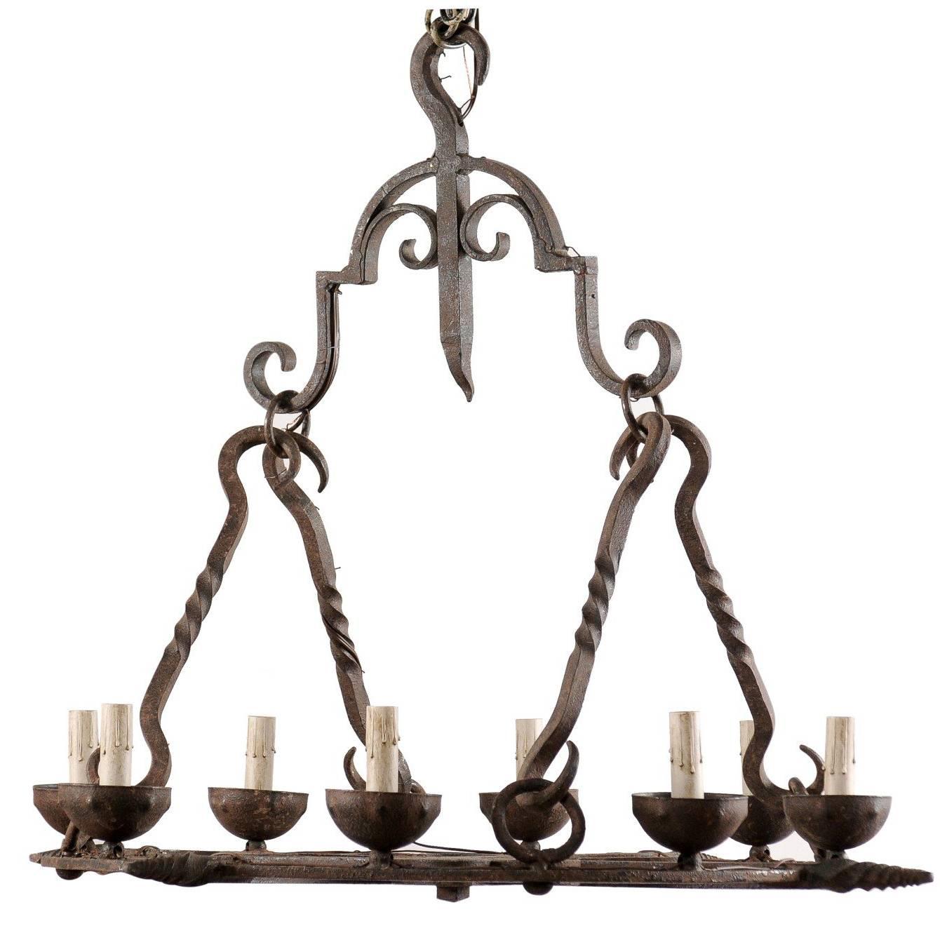 French Mid-Century Eight-Light Forged Iron Chandelier with Hooks and Scrolls For Sale