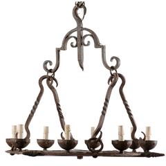 French Mid-Century Eight-Light Forged Iron Chandelier with Hooks and Scrolls