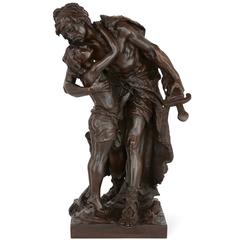 Antique patinated bronze sculpture of a father and son embracing by Henri Plé