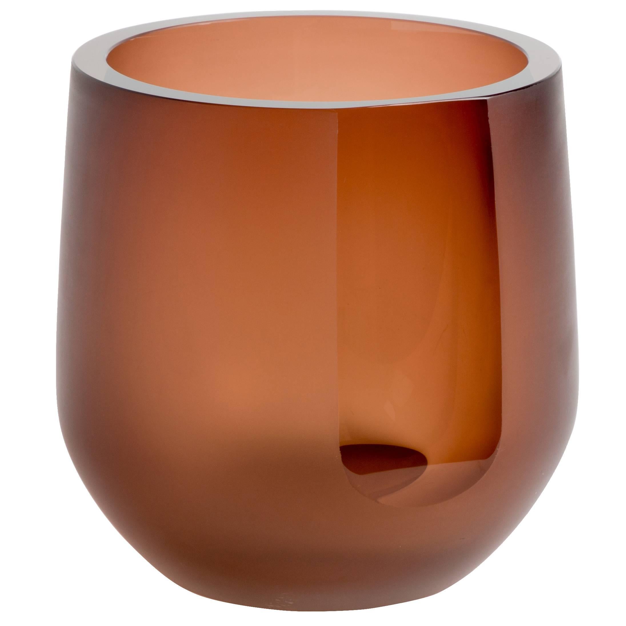 The Porto Ice Bucket is a simple exercise in optics and color. The 'Tea' color and reflective light are diffused by a surface etching. A single panel, or 