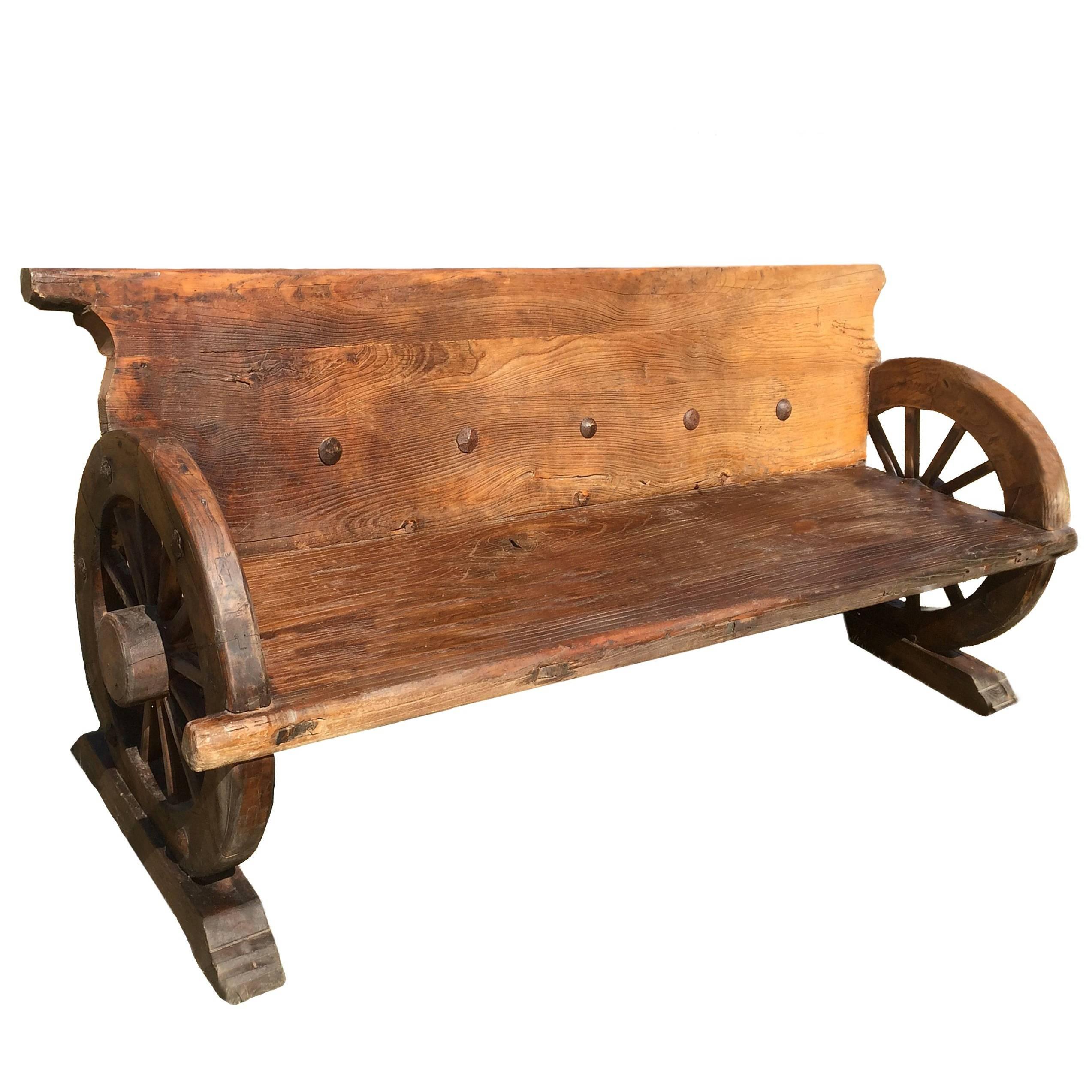 Rustic Bench with Antique Wheels and Iron Studs