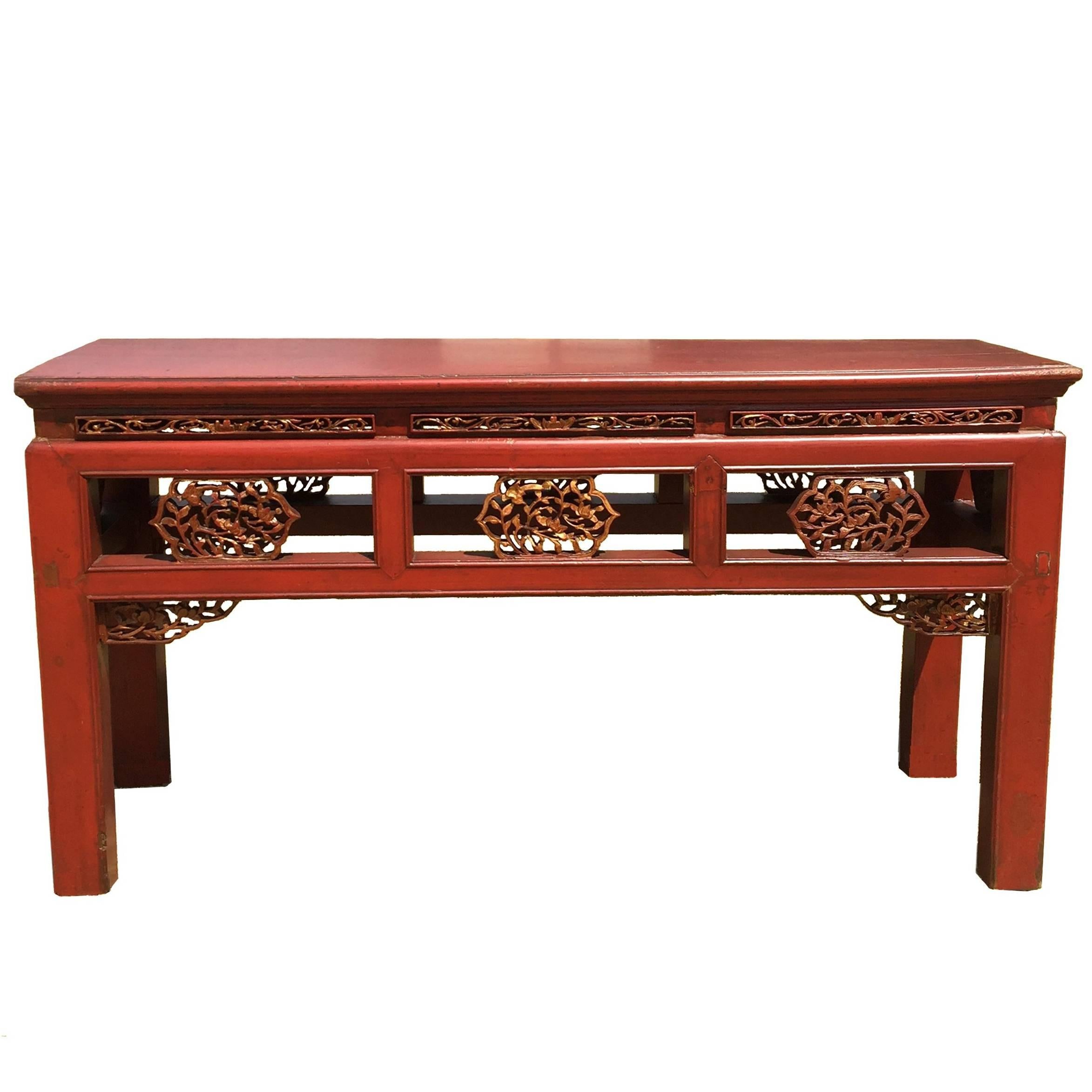 A pair of rare, antique Chinese benches, that are red lacquered and carved on both sides. 

The stunning benches have beautiful red lacquer and finely carved features. The carvings are delicate and deliberate showing scrolled floral and foliage. The