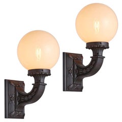Pair of Cast Iron Entry Sconces with Straw Opalescent Shades, circa 1920s