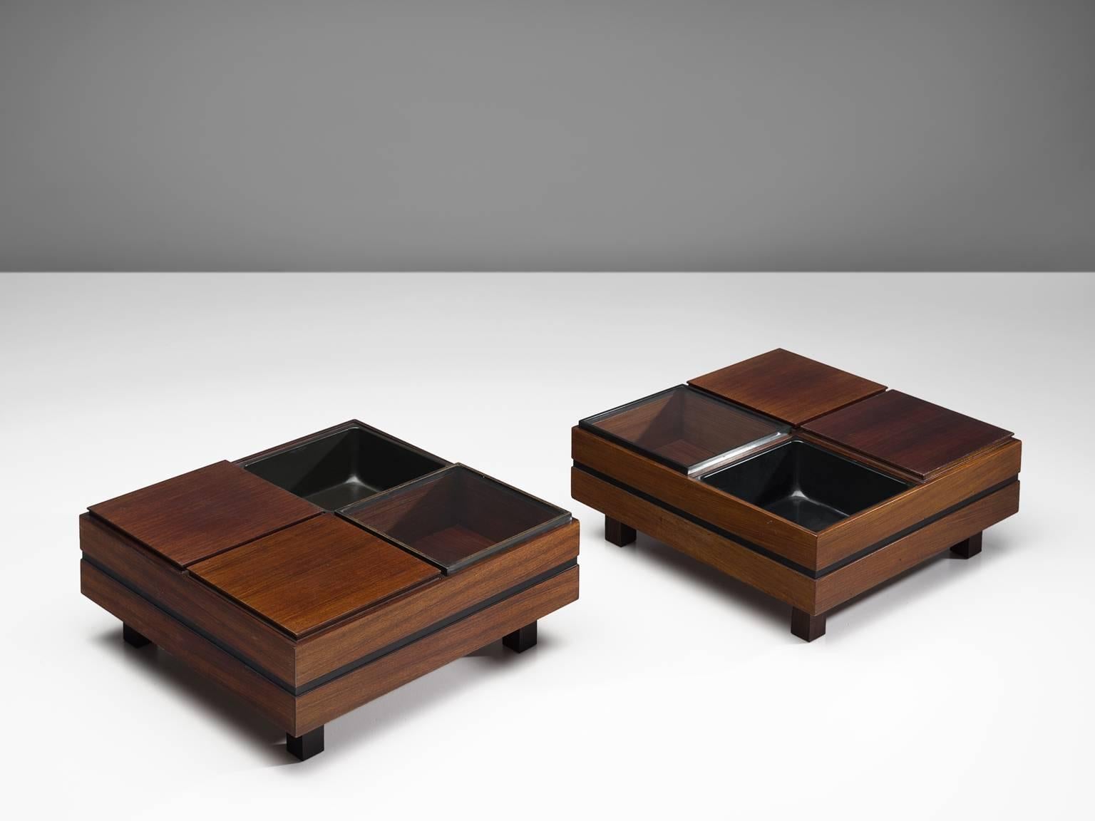 Produced by Sormani, pair of coffee tables, wood, glass, Italy, 1960s.

Architectural pair of side tables executed with four square elements each. The tables consist of a one empty element, one glass element and two wooden elements. The base of the