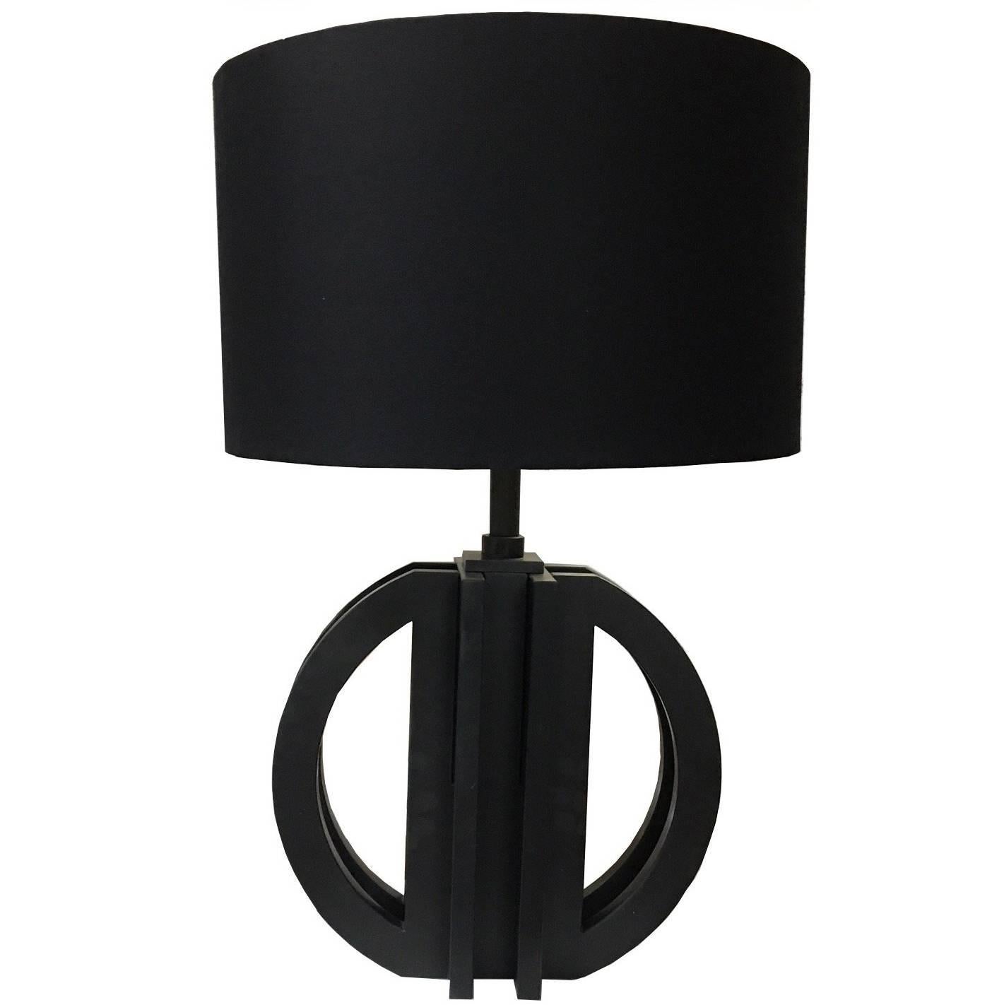 The black slate stone table lamp is part of a series of limited editions by Massimo Mangiardi. In this sculpture he uses both circular curves that inter-stack with slate columns creating a transparent yet strong stately presence, ethereal in nature.