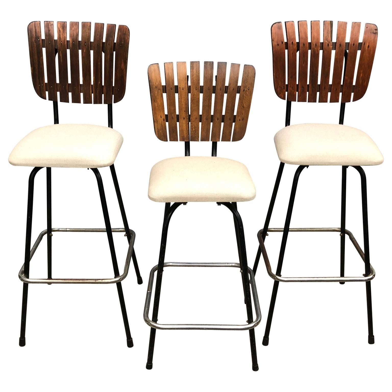 2 + 1 Mid-Century Modern bar stools in the style of Arthur Umanoff, seats are newly upholstered.
One pair and one bar stool that is lower than the pair
Seats swivel 360 degrees.

 
