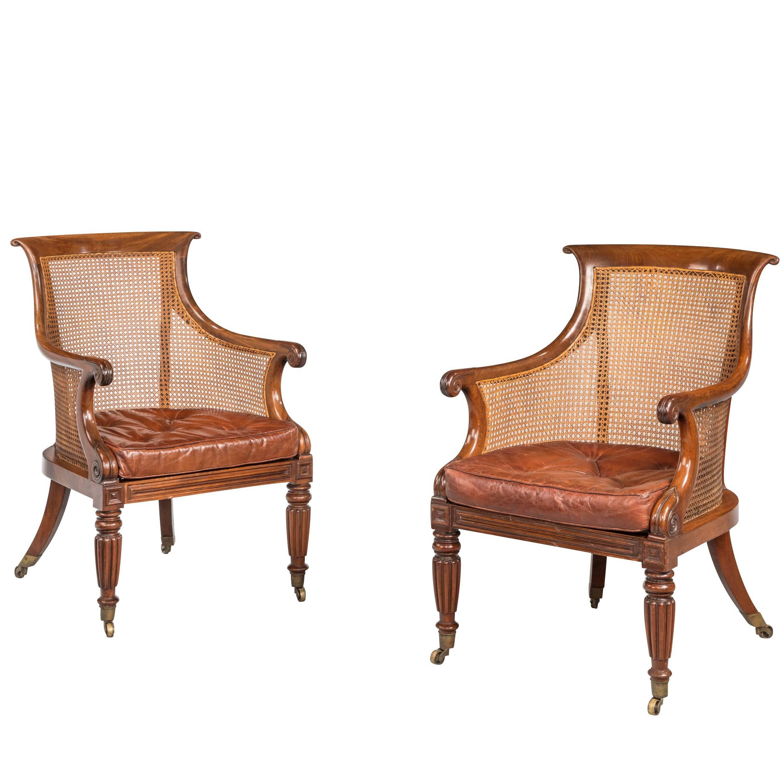 Pair of Regency Period Bergère Library Chairs with Swept Arms