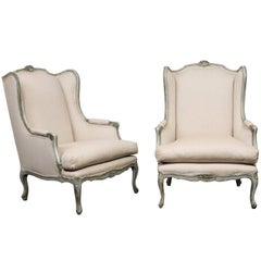 Pair of Mid-20th Century French Carved Wood and Upholstered Wingback Chairs