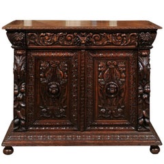 French Richly Carved Oak Buffet with Grotesque and Griffin Motifs from the 1880s