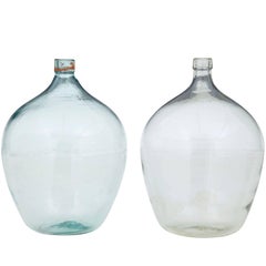 Two Large Glass Distillery Bottles
