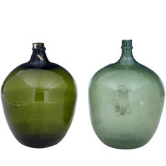 Two Large Green Glass Distillery Bottles