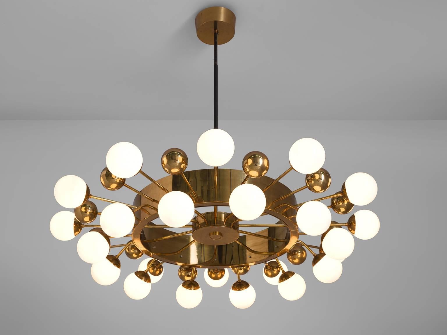 Large 2.2 mt / 7.2 ft sputnik handelier, in glass and brass, Europe, 1960s.

This sputnik chandelier is part of the midcentury design collection. The grand chandelier is executed with a brass fixture and opaline glass spheres. The chandelier exists