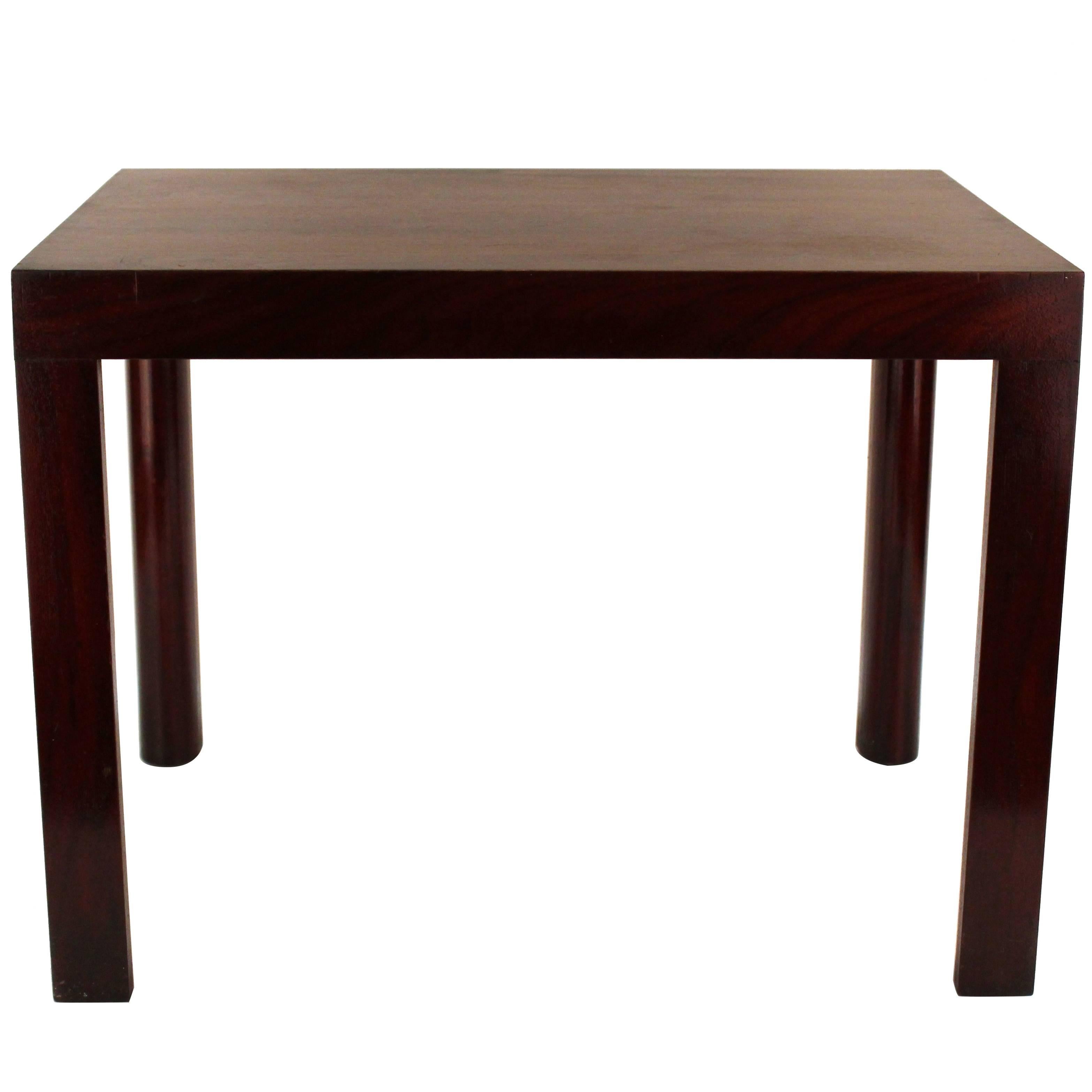 A group of three Enfield side tables. Wood with dark cherry varnish. Features simple rectangular shaped face and straight legs. Wear consistent with use. The set is in good condition.