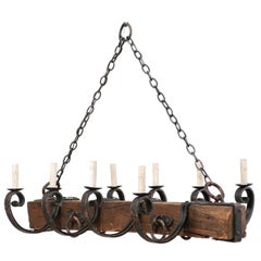 French Mid-20th Century eight-Light Rustic Wood and Scrolled Iron Chandelier