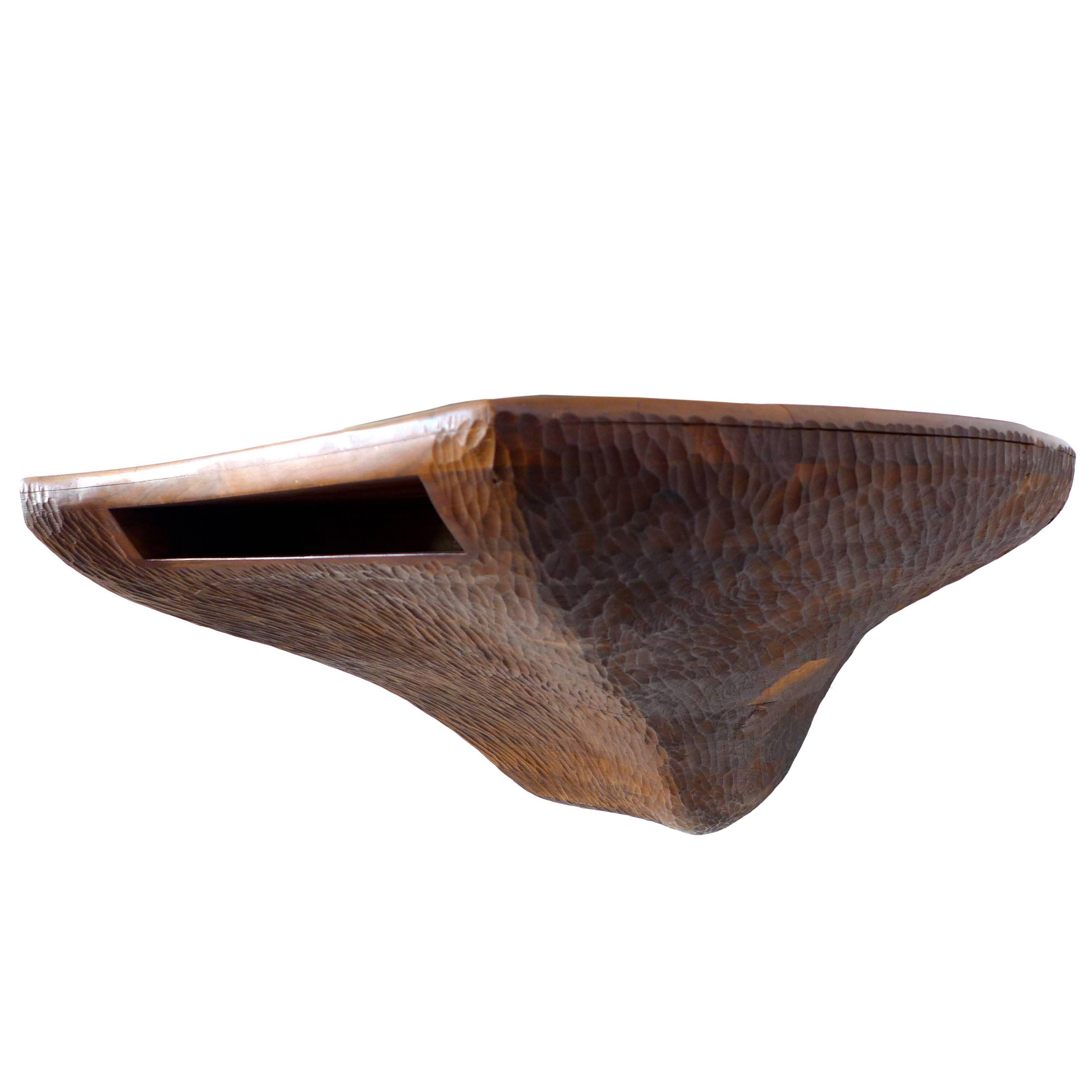 A very unusual and sculptural American craft, chip-carved and stack-laminated wood console. This hand-crafted, wall mount piece is a dramatic, artful and functional furniture statement. It's organically asymmetrical form and storage cut-out make for