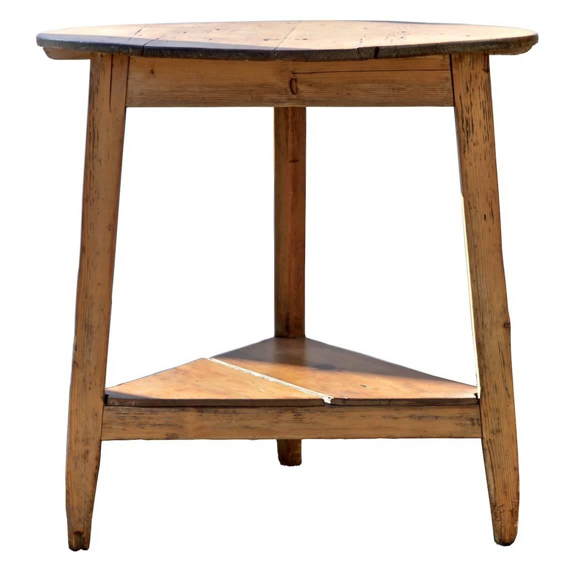 A fetching English cricket table of pine circa 1900 having a whitewashed finish. The ever useful and elegantly rustic side / end table can be successfully employed in such a wide range of interior spaces. It's a must have in every home. 