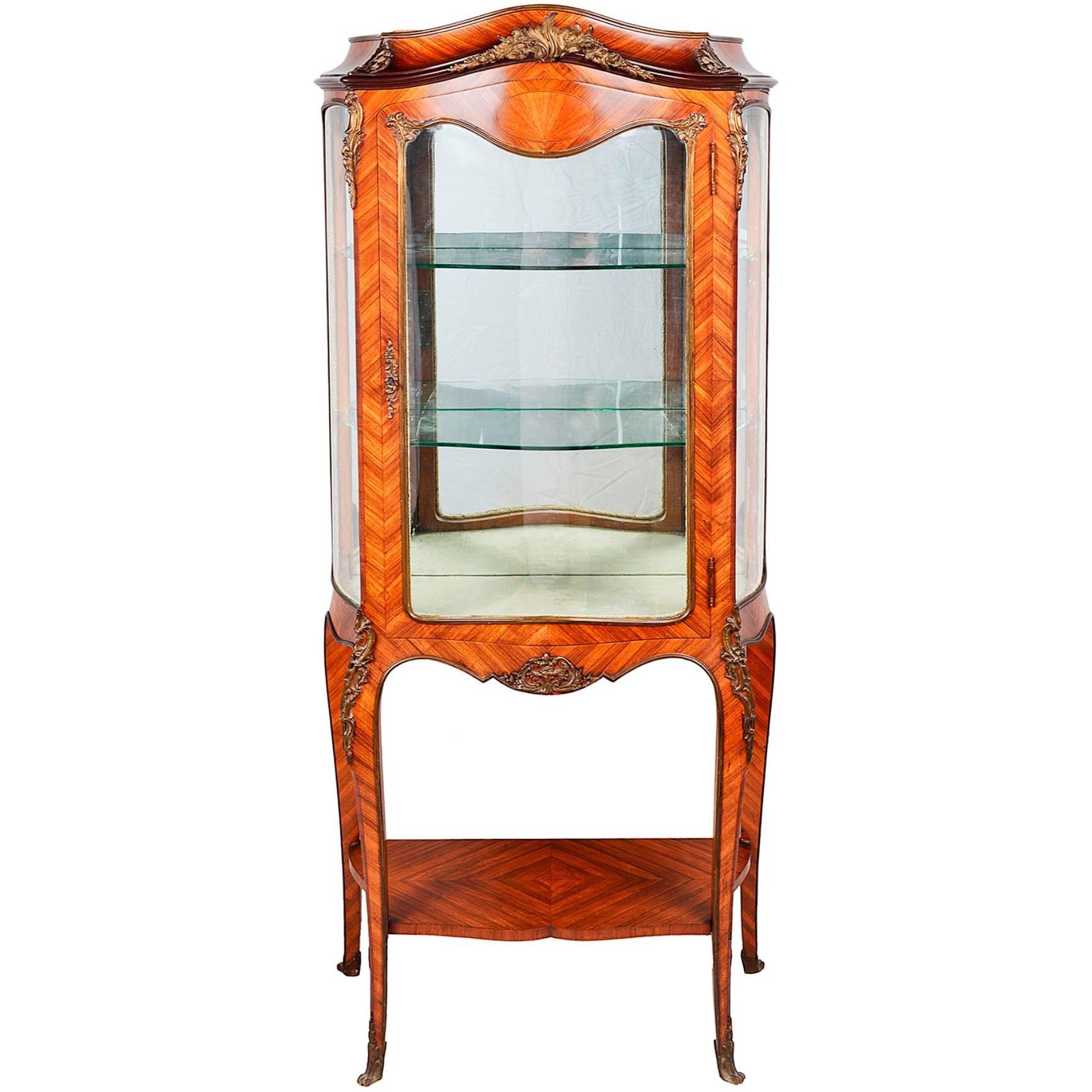 A very good quality late 19th century French kingwood vitrine. Having gilded ormolu mounts, a single glass door, opening to reveal two shelves within. Raised on cabriole legs, terminating in scrolling ormolu feet.